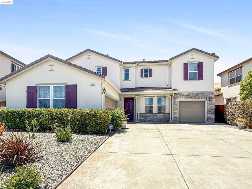 2921 Rio Verde Drive is a well-maintained, spacious, and thoughtfully upgraded home located in the sought-after San Marco neighborhood of Bay Point. This two-story residence offers over 3,545 square feet of comfortable living space, perfect for larger households or multigenerational living. The home features 4 generous bedrooms and 3.5 bathrooms, including a full bedroom and bath on the main level—ideal for guests, extended family, or a private office setup. Inside, the home boasts an open-concept layout with soaring ceilings and abundant natural light. The gourmet kitchen is equipped with granite countertops, ample cabinetry, a walk-in pantry, and a breakfast nook. The family room is prewired for surround sound, making it easy to create a home theater experience. Additional highlights include hardwood floors, recessed lighting, a gas fireplace, and dual-zone central heating and air conditioning. Owned by the original owner, this home sits on a large 10,890 sq ft lot with a backyard oasis and mature fruit trees. The front yard is low maintenance, and the 3-car garage offers ample room for parking and storage. Conveniently located across the street from Delta View Elementary and minutes from BART, freeway access, Sprouts, and more, this home blends comfort and accessibility.