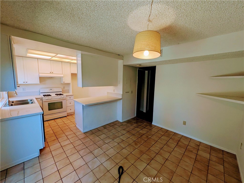This 3-bedroom townhome boasts fresh neutral paint and a wood-burning living room fireplace. Brand new kitchen. The patio is a great haven with brick planters, trees, and a wooden patio cover. All bedrooms enjoy ceiling fans. The master bedroom offers dual sinks, separate from the shower, and a huge closet! Beautiful offers winding paths, greenbelts, lush, well-maintained landscaping, tons of trees, a relaxing pool and spa, clubhouse, tennis courts, a basketball, a playground, and bar-b-ques in a park setting with ample guest parking and RV storage available.