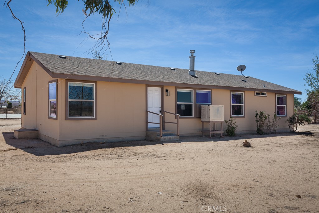 Escape to the High Desert east of Lancaster with this updated 3-bedroom, 2-bath home on 2.25 acres. Built in 2005, the home features new flooring, fresh paint, and a bright open kitchen with white cabinetry, stainless appliances, and a butcher-block island. The floor plan includes both a living room and a second living room, a dining area, and a private primary suite with walk-in closet and spacious bath. Outside, enjoy a detached two-car garage/workshop, fenced yard, and a large concrete pad ideal for RV parking, recreation, or a sports court. With room for animals, desert toys, and more, this property offers wide-open skies, mountain views, and true high desert living—all within reach of main roads for commuting convenience.