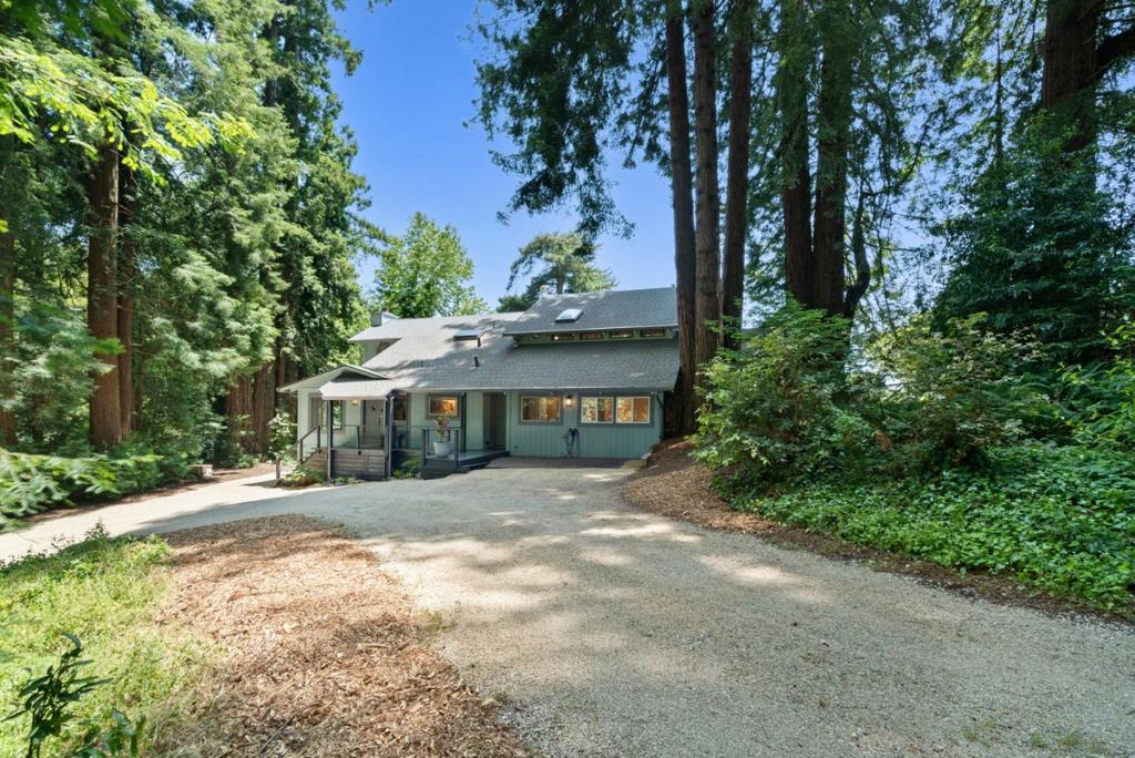 Experience the perfect blend of convenient Bay Area proximity and serene coastal living! Located on over 2.28 acres in a private cul-de-sac, it offers easy access from Mt Madonna County Park to Gilroy wineries/shops, as well as a short ride to the beach. This 4-bedroom, 3-bathroom home, surrounded by majestic redwood trees, offers 2,798 sq. ft. of comfortable living space with a large bonus room and views of the Pacific Ocean, Monterey, and Watsonville. The private, west-facing backyard features fruit trees, a pool, and a large workshop. It is perfect for entertaining and enjoying breathtaking sunsets. Step inside to find beautiful open beam ceilings, oak hardwood floors, a spacious living room, kitchen, and family room. The master suite includes a relaxing sitting room with a fireplace. Significant upgrades enhance this property, including a Trex deck, updated kitchen and bathrooms, Tesla Power wall/solar panels with EV charging, and a new well water maintenance system. This renovated home offers an unparalleled lifestyle.