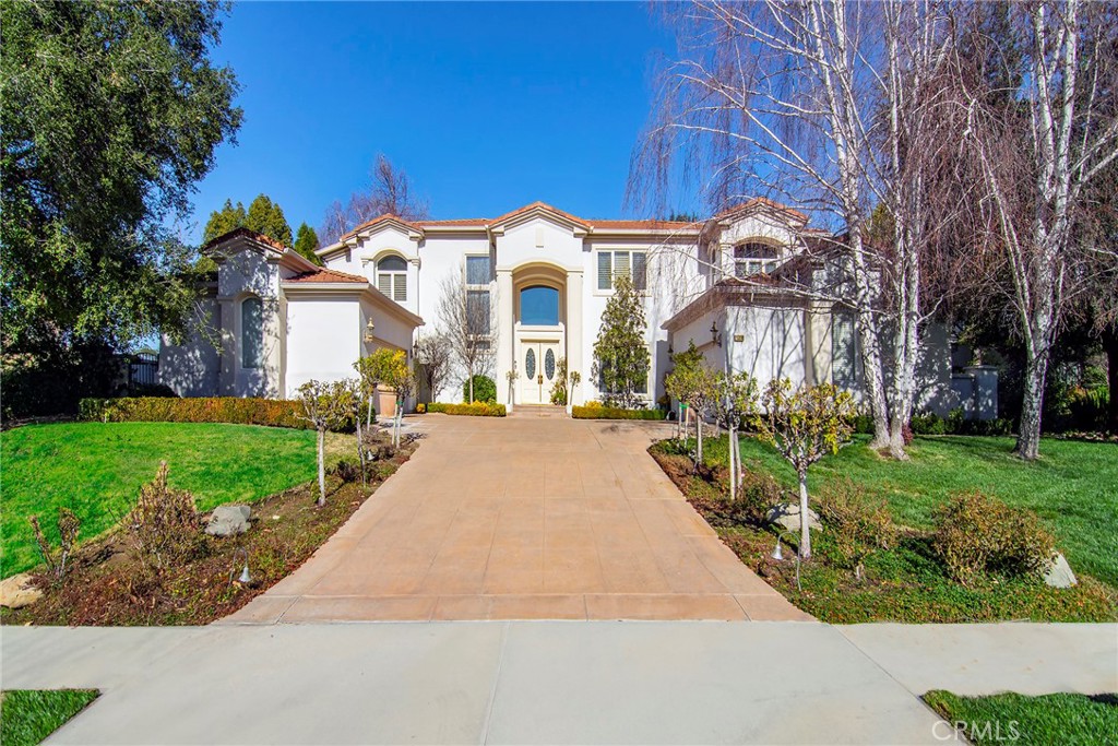 Located in the prestigious gated community of The Oaks, this warm and inviting residence offers the perfect balance of luxury living, thoughtful design, and resort-style amenities.
Step into a grand foyer entry that opens into a beautifully curated floor plan, ideal for both entertaining and everyday living. The gourmet kitchen features high-end appliances and flows seamlessly into the family and dining areas, while a formal living room with fireplace sets the tone for elevated comfort. Two downstairs bedrooms provide flexibility for guests, home office setups, or multigenerational living.
Upstairs, the oversized primary suite serves as a true retreat, complete with a sitting area, fireplace, spa-like bath, and custom built-ins. An upstairs office, expansive picture windows, and an in-home elevator connecting both levels round out the home's interior sophistication.
Outside, the private backyard is built for entertaining — enjoy two large covered patios, a built-in BBQ station, a generous grassy play area, mature trees, and peekaboo mountain views.