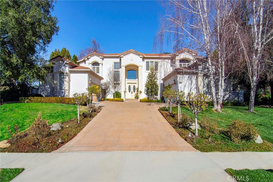 Located in the prestigious gated community of The Oaks, this warm and inviting residence offers the perfect balance of luxury living, thoughtful design, and resort-style amenities.

Step into a grand foyer entry that opens into a beautifully curated floor plan, ideal for both entertaining and everyday living. The gourmet kitchen features high-end appliances and flows seamlessly into the family and dining areas, while a formal living room with fireplace sets the tone for elevated comfort. Two downstairs bedrooms provide flexibility for guests, home office setups, or multigenerational living.

Upstairs, the oversized primary suite serves as a true retreat, complete with a sitting area, fireplace, spa-like bath, and custom built-ins. An upstairs office, expansive picture windows, and an in-home elevator connecting both levels round out the home's interior sophistication.

Outside, the private backyard is built for entertaining — enjoy two large covered patios, a built-in BBQ station, a generous grassy play area, mature trees, and peekaboo mountain views.