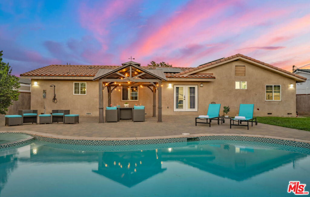 Modern family home with a fully fenced large yard,lush green grass, heated pool and spa & circle drive, two side entry with street parking. RV access/parking option and a 1/4 acre lot! Leased solar. 4 bedroom 3 bath (including the converted garage) Elegantly upgraded throughout, all appliances included. Not too far from shopping centers but also offers a nice neighborhood setting.