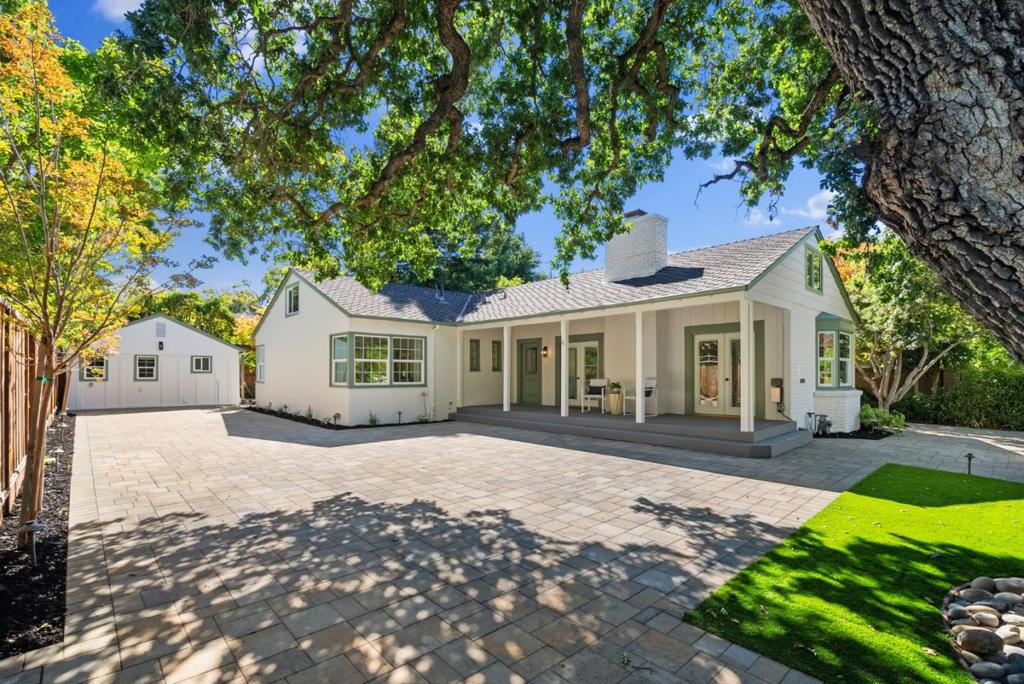 Bright and welcoming, this updated home enjoys a prime location minutes from Rinconada Park and downtown Palo Alto. A paver pathway winds through lush landscaping to a spacious front porch, setting the tone for inviting interiors with hardwood floors, fresh paint, updated bathrooms, and abundant natural light. Designed for entertaining and everyday living, the layout features a large living room anchored by a fireplace and an eat-in kitchen with appliances from brands like Jenn-Air. Three bedrooms include the primary suite with a beautifully finished bathroom, while a detached studio with its own kitchen and full bath adds comfort and flexibility. Outdoor spaces include the front porch, sunny patio, and a deck wrapped around a majestic redwood that provides shade and character. Air conditioning and driveway parking add convenience. Walter Hays Elementary, Greene Middle, and Palo Alto High are all within about a mile (buyer to verify eligibility).