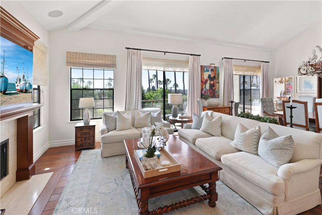 Experience coastal living at its finest in this beautifully remodeled and elegantly FURNISHED SINGLE-LEVEL residence. Located in prestigious 24-hour guard-gated community, Sea Island. This sophisticated home offers expansive views of the Back Bay, ocean, and city skyline. The spacious floor plan features 2 bedrooms, both with en-suite baths, plus an additional full bath. The primary suite is a private retreat with high ceilings, a fireplace, sitting area, dual walk-in closets, and a luxurious spa-inspired bath with soaking tub, oversized shower, dual sinks, and private water closet. The secondary suite offers its own tub/shower combo and dual sinks. A versatile den/office/reading area with natural light and nearby storage completes the layout. The open living and dining areas are warm and inviting, highlighted by a fireplace, custom built-ins, big screen TV, and panoramic views. A balcony off the dining room provides the perfect spot for morning coffee or evening breezes, complete with BBQ, seating, and outdoor dining. The gourmet kitchen features a breakfast nook with sunset views, counter seating, Sub-Zero refrigerator, Viking 6-burner range, and dual convection ovens. Additional highlights include: Separate laundry room with washer & dryer, garage with epoxy floors and built-in storage. There is ample closet space throughout. Community amenities include a resort-style pool, spa, clubhouse, tennis courts, and BBQ area. Ideally located near Fashion Island, Balboa Island, and Newport’s finest shopping, dining, and beaches. Offered fully furnished – move-in ready for a turnkey coastal lifestyle.