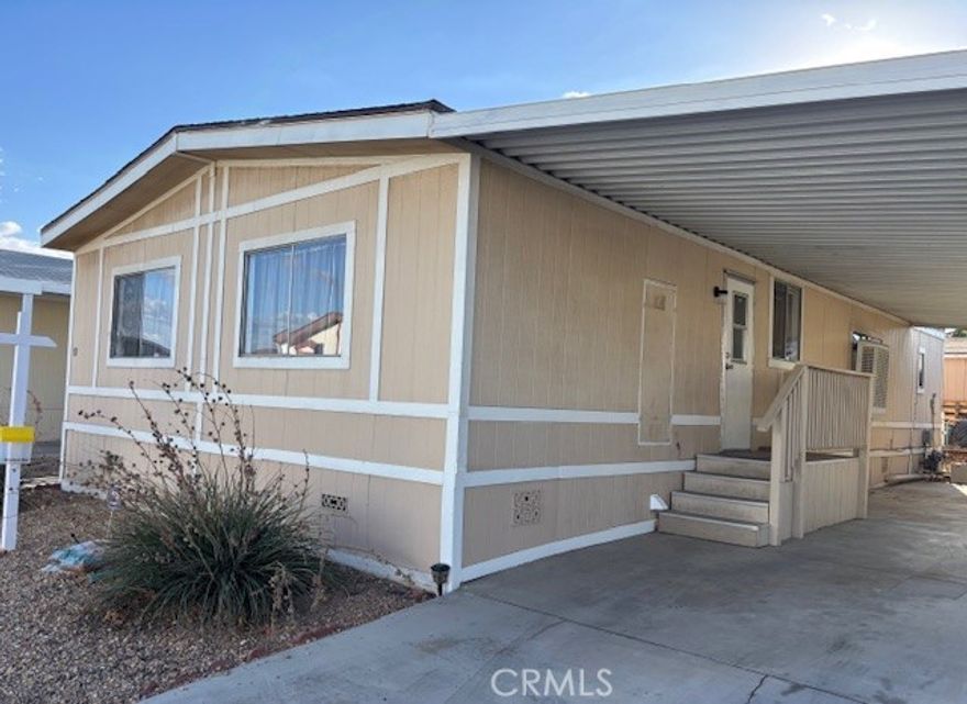 Nice double wide mobile home in Los Ranchos Park * This 3 bedroom 2 bathroom home has an open feel about it * Split floor plan * Cute Kitchen with stove, refrigerator, dishwasher, garbage disposal and touch activated faucet * Dining area off kitchen opens into the living area * 2 bedroom on one side * Primary bedroom on the other side with a vanity area and a large walk-in closet, Large tub and cabinet with one sink but plenty of counter space * Large front porch with carpet * Carport is concrete with covered awning * Small back yard with chain link fencing and gate * Some rock-scape and a few bushes for easy care * Storage Shed with concrete slab * New Carpet and paint * Still needs a little more TLC * Come and check it out. Los Ranchos Community has 2 club houses, 3 pools, a play ground, Tennis and Basket Ball courts and a Lake to go fishing.
