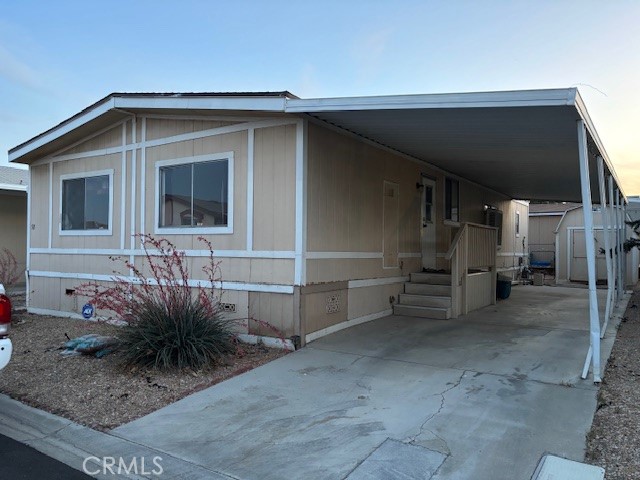 Nice double wide mobile home in Los Ranchos Park * This 3 bedroom 2 bathroom home has an open feel about it * Split floor plan * Cute Kitchen with stove, refrigerator, dishwasher, garbage disposal and touch activated faucet * Dining area off kitchen opens into the living area * 2 bedroom on one side * Primary bedroom on the other side with a vanity area and a large walk-in closet, Large tub and cabinet with one sink but plenty of counter space * Large front porch with carpet * Carport is concrete with covered awning * Small back yard with chain link fencing and gate * Some rock-scape and a few bushes for easy care * Storage Shed with concrete slab * New Carpet and paint * Still needs a little more TLC * Come and check it out. Los Ranchos Community has 2 club houses, 3 pools, a play ground, Tennis and Basket Ball courts and a Lake to go fishing.