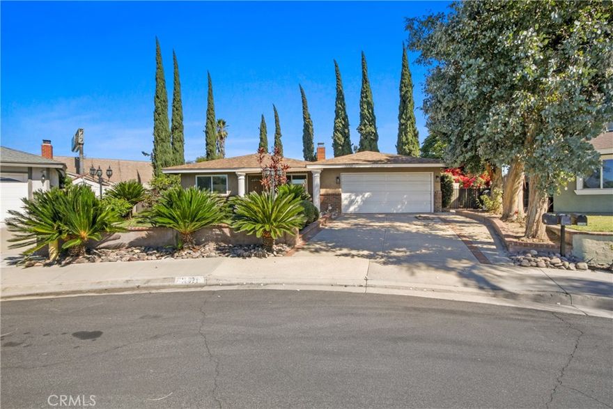 Welcome to this inviting single-level home tucked away at the end of a peaceful cul-de-sac in a quiet, established neighborhood. This well-maintained property features four spacious bedrooms and two updated full bathrooms, offering plenty of room for families or those needing extra space. Enjoy a generous 20x20 family room equipped with its own HVAC mini-split system and a cozy wood burning fireplace—perfect for relaxing or entertaining. The living room boasts a classic gas fireplace, creating a warm and welcoming atmosphere. For the cooking enthusiast, the home features a large kitchen with granite countertops and ample cabinet space, making meal preparation a breeze. An indoor laundry area adds convenience to your daily routine. Step outside into the sizable backyard, where you'll find mature fruit trees, open landscaping, and plenty of room for gardening, outdoor activities, or simply enjoying nature. Conveniently located near shopping centers, public transportation, and the 60 Freeway.