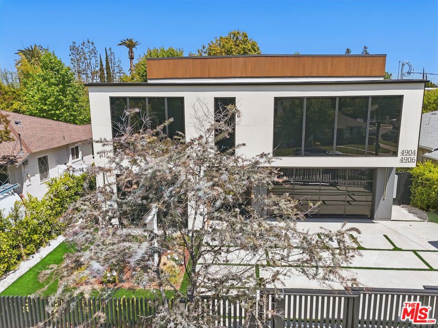 Nestled in a prestigious neighborhood, this newly constructed masterpiece redefines luxury living with its striking modern design and meticulous attention to detail. Ideally located near upscale boutiques, fine dining, Whole Foods, and more, this home blends opulence and convenience. Step inside to an expansive, light-filled interior featuring stunning hardwood floors, soaring windows, and exquisite high-end finishes. The open-concept layout is anchored by a double-sided marble fireplace, seamlessly connecting the elegant family room and sophisticated dining area, creating warmth and grandeur. The chef's kitchen is a culinary haven, boasting an 8-burner Forno stove, Zline microwave drawer, double-sided refrigerator, and hidden pantry with its own sink and dishwasher. At the center is a spacious island with a built-in sink, perfect for casual meals and gourmet prep. Adjacent is a chic bar area with a wine fridge, setting the stage for effortless entertaining. The main level also includes a stylish powder room and en-suite guest bedroom for privacy and convenience. Modern conveniences include security cameras at the front and back, plus ceiling speakers on the first floor and backyard for music or enhancing your smart home experience. Outdoors is an entertainer's paradise with a pool, spa, cabana with retractable roof, fire pit, and an outdoor kitchen featuring a grill, refrigerator, wine fridge, sink, beer tap, and pizza oven. Even more entertainment awaits on the rooftop deck, with a second BBQ, grill, wine fridge, fire pit, and ambient lighting, offering stunning views. The upper level impresses with a well-designed landing, a fully equipped laundry room, and four en-suite bedrooms, three featuring floor-to-ceiling tinted windows. The crown jewel is the opulent primary suite, a private retreat with a personal kitchenette, massive walk-in closet, and spa-like bath with dual sinks, makeup vanity, soaking tub, and dual-head shower. A marble fireplace adds warmth, while sliding doors open to a private terrace overlooking the pool and spa, with a spiral staircase to the backyard. Additional features include fully paid solar panel,a floating staircase, two-car garage with epoxy floor, and private driveway gate. Combining elegance with practicality, this extraordinary home offers an elevated lifestyle in a prime location.