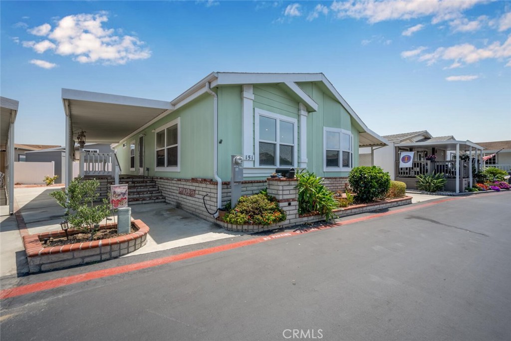This 55+ community home really delivers! Situated in the highly desirable gated community of Rancho del Rey Mobile Estates Adjacent to nearby Huntington Harbour and convenient to shopping, sandy beaches, freeways, restaurants, airports, hospitals and much more. This home offers a peaceful and quiet interior location that is convenient to the main clubhouse amenities that feature a year round heated pool and spa, sauna, banquet facilities, golf putting green, billiard tables and outdoor barbeque patio area. Interior features of this home include forced air heating and cooling, dual pane windows, tasteful laminate flooring, open floorplan skylights in the living room that provide natural lighting. The master bedroom features plenty of space for a king sized bed and furniture and a spacious walk in closet. The master bath offers dual sinks with an easy walk in shower and a linen closet for towel storage. Exterior features include covered two car carport, covered side porch with nicely appointed masonry work adding curb appeal and low maintenance. Other exterior features include a spacious storage shed and vinyl fencing for added privacy. Rancho del Rey is hands down the best value Manufactured Home Park in Huntington Beach offering an affordable option to reside in a Multimillion neighborhood for a fraction of what others pay in the same area.