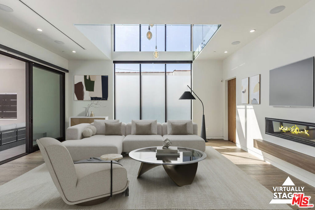 Welcome to a truly elevated living experience in this modern five-bedroom, five-bathroom residence, ideally located just moments from La Brea Avenue and minutes from The Grove, premier shopping, acclaimed dining, and vibrant cultural destinations.Thoughtfully designed for both style and comfort, this home offers expansive open-concept living spaces that flow effortlessly into the private, landscaped backyardcreating a seamless indoor-outdoor connection that perfectly suits the Southern California lifestyle. The spacious layout offers both functionality and elegance, with clean architectural lines, high-end finishes, and a calming sense of retreat throughout.Each of the five bathrooms is tastefully appointed with contemporary fixtures and refined details, offering comfort and convenience for both residents and guests. The well-designed kitchen serves as the heart of the home, with ample space for cooking, gathering, and entertaining in style without being overly formal.A stunning rooftop deck crowns the property, offering panoramic views of the city skyline ideal for sunset cocktails, morning coffee, or simply enjoying LA from a new perspective. Located near major film and music studios with easy access to most of LA, including DTLA and all major freeways. Sophisticated, spacious, and filled with natural light, it captures the very best of modern Los Angeles living.