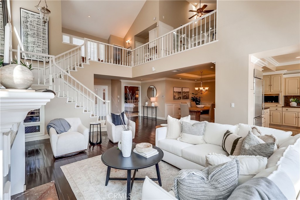Welcome to this STUNNING single-family home in the highly desirable Bixby Village community, perfectly situated on the 5th tee of the Bixby Village Golf Course. From the moment you step through the private front courtyard, you’ll feel the warmth and charm this home offers. Inside, the open-concept design is highlighted by soaring cathedral ceilings and natural light streaming through the floor to ceiling windows. Step outside to the brick patio, where an automatic retractable awning creates the perfect space for relaxing or dining al fresco while overlooking the lush golf course. Recently redone hardwood floors flow seamlessly throughout most of the downstairs. The inviting living room is a wonderful place for a cozy night in or to host a house full of people. It features seamless access to the backyard, surround sound, a fireplace, & soaring ceilings. The coveted downstairs primary ensuite is a true retreat, complete with its own fireplace, a spa-like bathroom with large shower and jacuzzi tub, and a cedar-lined walk-in closet! The remodeled kitchen is perfect for entertaining & boasts granite countertops, abundant cabinet space, and a chef’s range—ideal for a large crowd or everyday cooking. Upstairs, you’ll find two generously sized bedrooms—one with beautiful golf course views—plus a second full bathroom and a dedicated office with built-ins that could easily be converted into a fourth bedroom. A convenient laundry area completes the upper level. The garage is a dream in itself with new epoxy flooring, built-in storage, and a spacious 350 sq. ft. loft featuring skylights, cable TV, ceiling fan, built-ins, its own electrical sub-panel, and plenty of additional storage. This home also includes a whole-house water treatment and drinking system by PURONICS, brand new HVAC ducting, new landscaping front & back, new intercom system, too much to list. Bixby Village is a beautifully maintained, professionally managed community offering resort-style amenities including two pools and a clubhouse. Close to CSULB, the beach, freeway access, 2nd & PCH shopping & restaurants & more! This is Southern California living at its best—don’t miss the opportunity to make it yours!