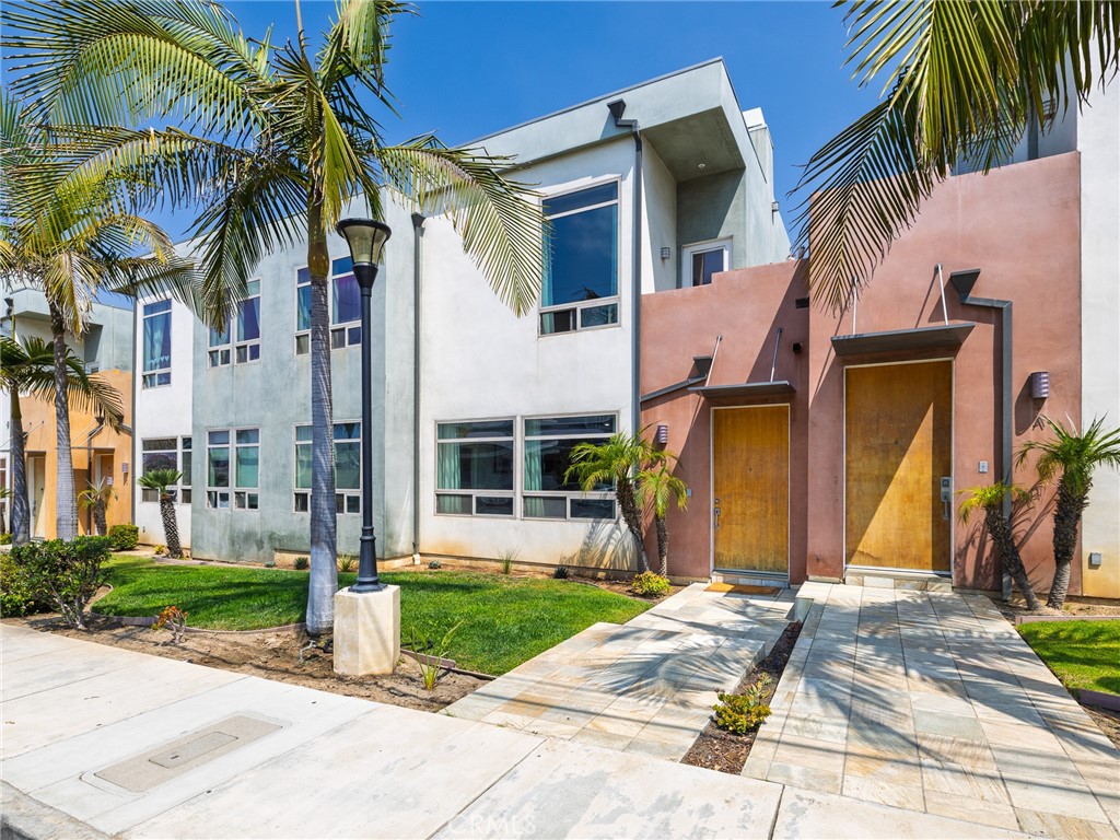 This beautifully updated 2 bedroom, 2.5 bathroom home offers just under 1800 sq ft of thoughtfully designed living space. The main level features new vinyl plank flooring, a private bedroom with an en-suite bathroom as well as two additional flexible spaces that can be used as a family room, office space, and/or a garage. The second floor showcases hardwood floors and an open-concept layout between the spacious kitchen and living room, complete with an electric fireplace. The kitchen itself has a large island, wine fridge, dishwasher, and plenty of storage.The spacious primary suite features a walk-in closet, a dual vanity bathroom, a large shower with seating, and a private balcony. A convenient half bath and stacked laundry are also located upstairs. The updated stairwell off the living room leads to a brand-new private deck with gas and water lines and electrical outlets—ideal for entertaining. Additional highlights include a new A/C unit, new Milgard windows, plenty of parking in the garage and/or carport, and ample storage under the stairs.
