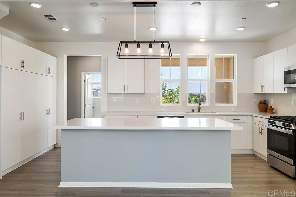 MOVE IN READY - Welcome to Your Dream Home in Playa Del Sol! Step into modern comfort and style in this beautiful tri-level 3-bedroom, 2.5-bathroom townhome, ideally located in the highly sought-after Playa Del Sol community. This desirable end unit offers extra privacy and overlooks the playground area, just steps from the sparkling community pool. The home is filled with natural light and offers upgrades including a tankless water heater, epoxy-coated 2-car attached garage, and LOW monthly solar. Enjoy open-concept living with an expansive kitchen featuring an oversized island perfect for entertaining. Fresh new carpet leads upstairs to the bedrooms, where you’ll find a convenient stackable washer & dryer on the same level. The spacious primary suite features a walk-in closet and a private en-suite bathroom for your comfort. Resort-style amenities include a pool, spa, gym, clubhouse, BBQ area, and playground, everything you need for a vibrant, active lifestyle. Located just minutes from Sesame Place San Diego, North Island Credit Union Amphitheater, schools, shopping, and popular dining spots. Don’t miss your chance to own a stylish home in one of San Diego’s most dynamic communities! FHA & VA APPROVED!