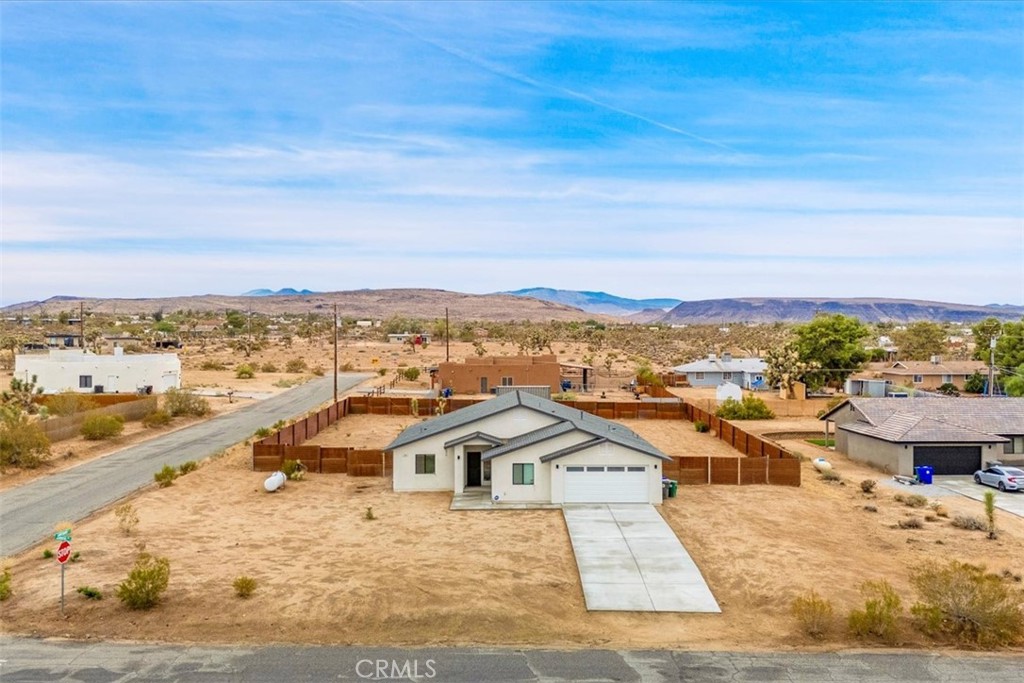 Stunning 4-Bedroom, 2-Bath Home on the Mesa in Yucca Valley!
Set on a desirable corner lot with over half an acre of land, this 2022-built home offers the perfect blend of modern comfort and desert charm. Featuring 1,902 sq. ft. of open living space, soaring ceilings, and polished concrete floors throughout, this property is designed with both style and functionality in mind.
The heart of the home is the expansive kitchen, complete with quartz countertops, stainless steel appliances, and a generous island that flows seamlessly into the spacious living room—ideal for hosting family and friends.
Each of the four bedrooms offers plenty of room to make your own, while the primary suite is a true retreat with high ceilings, double vanity sinks, a huge walk-in closet, and a spa-like bathroom.
Additional highlights include central heating and A/C, an indoor laundry room, and a covered back patio—perfect for enjoying peaceful mornings or relaxing evenings under the desert sky.
This move-in ready home checks every box. Don’t miss your chance to own a modern desert oasis in beautiful Yucca Valley. Schedule your showing today!