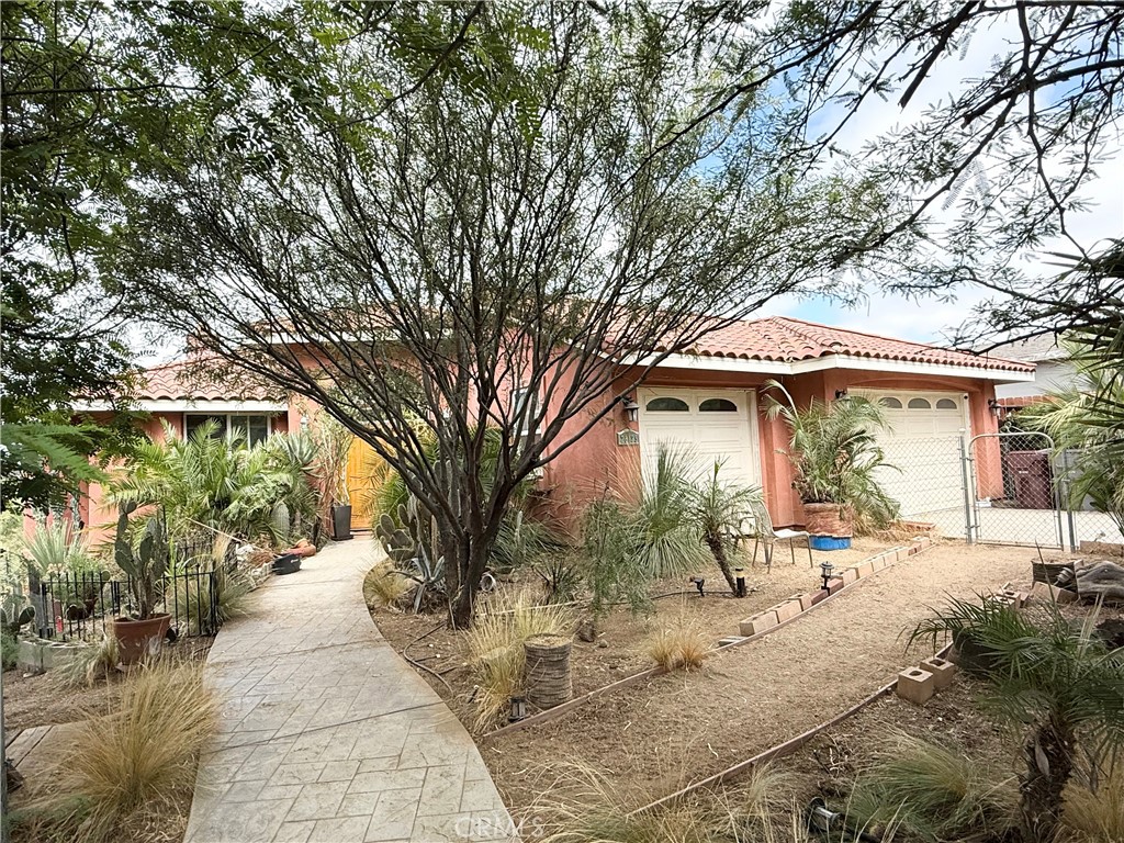 Don't miss out on this charming 2007 custom built home nestled on a generous .25-acre lot! This beautiful home features 3 spacious bedrooms and 2 bathrooms offering both comfort and functionality. This property is very unique being one of the very few limited newer custom builds designed with high vaulted ceilings with custom carved designed wood beams throughout the entire interior of the home. You'll also appreciate the very spacious connected 3-car garage that has a rear 3rd tandem garage door that leads to the backyard and providing ample space for vehicles and storage. The gated driveway ensures privacy and security. Step outside into the oversized backyard with an above ground pool that has newer pool equipment, a perfect setting for relaxation or outdoor activities. Enjoy the tranquil ambiance created by the outside pool deck and the stunning orchid trees that enhance the landscape. Conveniently located just minutes from shopping, dining, schools, and major freeways, this home offers the ideal combination of serenity and accessibility. Don’t miss the opportunity to make this peaceful retreat your own!