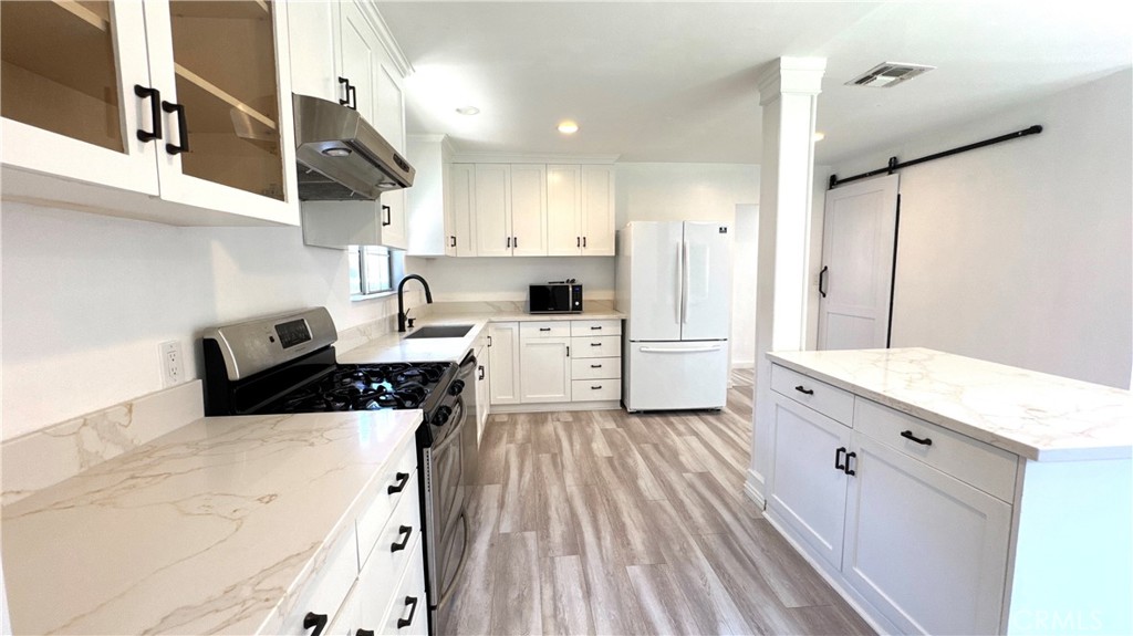 2 HOUSES ON 1 LOT! 6916 & 6918 Claire Ave, A Rare Opportunity with Attached ADU!
Nestled in the heart of highly desirable Reseda, this exceptional property offers a beautifully updated 3-bedroom, 2-bathroom single-family home with approximately 1,800 sq. ft. of thoughtfully designed living space, plus an attached 1-bedroom, 1-bathroom Accessory Dwelling Unit (ADU) for added flexibility and value. Step inside to discover a spacious, stylish kitchen that serves as the true centerpiece of the home. Featuring a grand center island, sleek granite countertops, and custom cabinetry, this culinary space is both functional and elegant, perfect for home chefs and entertainers alike. The open-concept layout is enhanced by newer recessed lighting and double-paned windows, which flood the home with natural light and create an inviting atmosphere. Outdoors, a private rear yard offers a serene retreat surrounded by lush landscaping. Enjoy the bounty of three mature fruit trees, tangerines, lemons, and pomegranates. Adding a fresh, organic touch to your backyard haven. The extra-wide concrete driveway provides ample parking for residents and guests alike. Conveniently located near shopping, dining, parks, and major thoroughfares, this property offers easy access to all that Reseda has to offer. Whether you’re seeking a peaceful primary residence, a lucrative investment, or both, this home delivers. The attached ADU unlocks endless possibilities. Use it as a guest suite, home office, or a rental property to generate income. Don’t miss this rare opportunity to own a versatile property in one of Reseda’s most vibrant neighborhoods!
