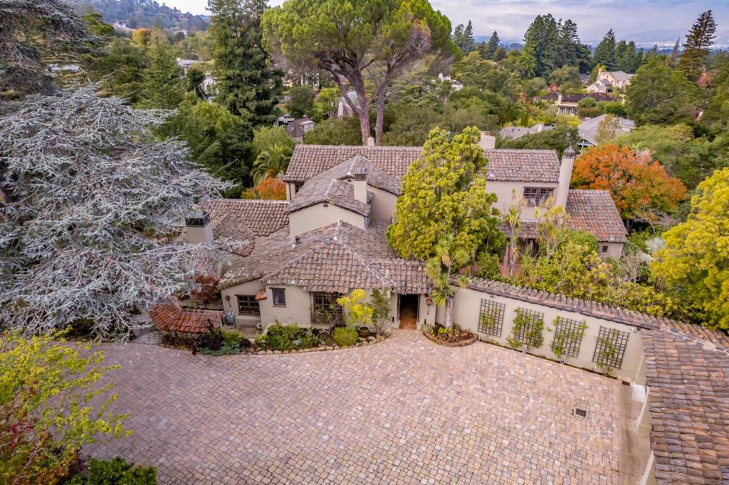 Extraordinary Hillsborough Estate in a Private Setting! Seemlessly blending the architectural splendor of a 1930's Spanish Hacienda with contemporary updates and resort-like amenities (pool, tennis court, cabana, and guest house), this cherished Hillsborough estate is perfectly situated on a gated lot of approximately 2.55 acres. The main residence exudes period charm with Gothic arches, groin-vaulted ceilings, and intricate tile and ironwork. The allure continues with nearly every room graced by a towering all-wood beamed ceiling and with access to the grounds or to a balcony. A soft neutral palatte creates a canvas ready for any personal style. Designed with lavish entertaining in mind, there are grand formal rooms, a spacious gourmet kitchen with top-tier appliances, an expansive family room, and a lower-level recreation room - each providing an ideal setting for gatherings of any scale. 5 bedrooms, each with its own bath, including a lavish primary suite. Lush gardens & setting!