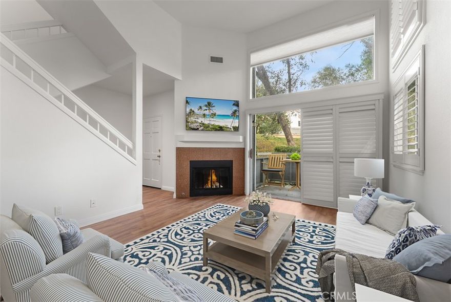 Discover your serene retreat in this beautifully updated stylish 2-bedroom end-unit townhouse, perfectly nestled in the heart of Laguna Niguel. Bathed in natural light, this home features soaring vaulted ceilings and picturesque views of lush trees and scenic walking trails. The unique open-concept floor plan flows effortlessly, showcasing a cozy fireplace in the inviting living area and a modern kitchen designed for culinary enthusiasts. The kitchen boasts sleek stainless steel appliances, stunning stone countertops, and a tumbled travertine backsplash, complemented by elegant shaker-style maple cabinets. Enjoy sunlit mornings in the charming eat-in dining nook with a bay window.

This home offers two spacious master suites, each with its own private full bathroom, ensuring comfort and privacy. Additional highlights include a convenient laundry room, a two-car garage with direct access, fresh paint, new carpet, a newer AC and furnace, and a water softener for enhanced living comfort.

Ideally located near Laguna Niguel Lake, Crown Valley Community Park, and the Laguna Niguel Botanical Gardens, this townhouse provides easy access to scenic walking and biking trails, as well as nearby shopping, dining, and the coastal charm of Laguna Beach and Dana Point. Welcome home to tranquility and style! Welcome home to 24839 Nueva Vista.