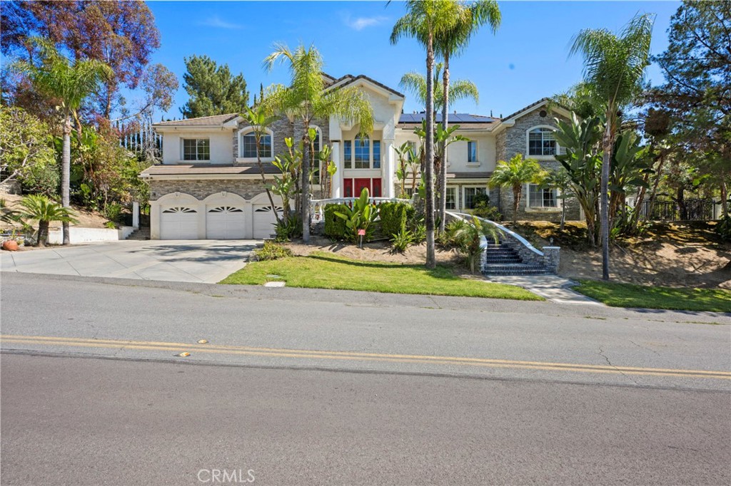 Welcome to this beautifully home located in the highly sought-after neighborhood in "The Country Estates" of Diamond Bar! Situated on a tranquil cul-de-sac, this spacious 6-bedroom, 5.5-bathroom home offers over 6500 of living space and is perfect for family living and entertaining. As you enter the home, you’re greeted by a bright and airy open floor plan with high ceilings and an abundance of natural light pouring in. The formal living room features a cozy fireplace and seamlessly flows into the dining area, ideal for hosting guests. The kitchen is a chef’s dream, complete with stainless steel appliances, granite countertops, ample cabinetry, and a center island. Upstairs, the luxurious master suite offers a private retreat with a large walk-in closet and an en-suite bathroom featuring dual vanities, a soaking tub, and a separate shower. An adjoining enclosed sunroom offers a tranquil space for exercise or quiet contemplation, blurring the lines between indoor and outdoor living. Two additional en-suite bedrooms and two further well-appointed bedrooms share a bathroom to ensure ample space for family and guests. A convenient main-level bedroom with a full bathroom enhances the home's versatility. Notable features include a custom oak library with exquisite coffered ceilings and wainscoting. Step outside into the serene backyard, featuring a sparkling pool, is perfect for al fresco dining or relaxing with family and friends, with lush landscaping providing privacy and tranquility. This home includes a three-car garage, central air conditioning, and an upstairs laundry room, providing modern conveniences. Located just minutes from top-rated schools, shopping, dining, and parks, this home offers both convenience and luxury. Don’t miss your chance to own this spectacular Diamond Bar gem! Schedule your private showing today!