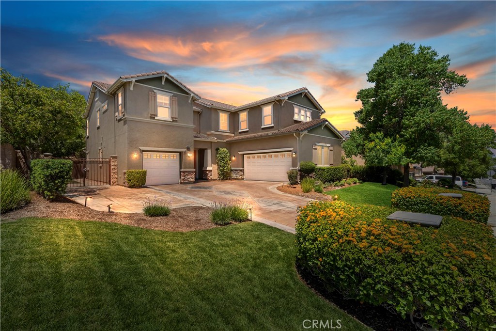 Located just up the street from the prestigious Woodcrest Christian School, this beautifully maintained 5-bedroom home in Riverside’s sought-after Orangecrest neighborhood offers the ideal layout for families and multigenerational living. Step inside to elegance with soaring ceilings, crown molding, recessed lighting, and contemporary interior paint that set the tone for this casually refined home. The open-concept kitchen features granite countertops, a designer tile backsplash, rich wood cabinetry, stainless steel appliances, and a large island with bar seating next to a dining area perfect for casual meals or hosting. The adjoining family room features wood-look tile flooring, a stacked stone fireplace, built-in media center, and custom shelving all opening to a backyard made for entertaining. The first-floor bedroom with its own upgraded ensuite bath is perfect for guests or in-laws, while the formal dining room adds a touch of elegance for holidays and special occasions. Upstairs, the spacious primary suite offers upgraded baseboards, a ceiling fan, and an ensuite with double sinks, a soaking tub, walk-in shower, and oversized closet. Across the hall, the versatile bonus room provides space to work, relax, play or make it your own Home Theatre! Three more secondary bedrooms -- each with ceiling fans and ample storage -- including a Jack-and-Jill bath and an additional full hallway bath. The backyard is your private retreat, featuring a covered Alumawood patio, built-in fire pits, a media wall, cement patio seating, mature landscaping, a dog run, and even a small turtle pond. Additional highlights include two separate garages (one 2-car and one 1-car) both with epoxy flooring. Close to parks, shopping, dining, and top-rated schools, this home blends thoughtful design, prime location, and comfort in one complete package.