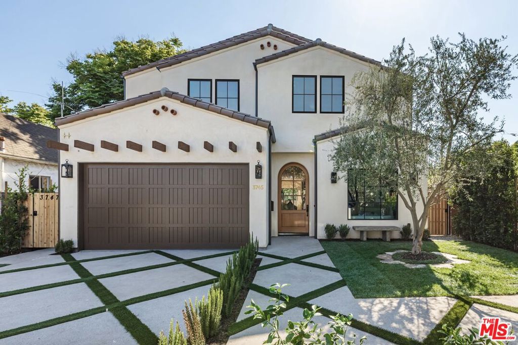 Newly completed Spanish Coastal Transitional showcasing quality craftsmanship, immaculate design, and indoor-outdoor living in one of the most sought after neighborhoods of Mar Vista. Built and designed by Bespoke Homes California, this custom new construction offers 5 bedrooms, 6.5 bathrooms and 3,871 SF of living space including a detached 406 SF ADU. The main floor welcomes you with elegant arched entries, abundant natural light, and oak engineered hardwood floors throughout. The designer-done chef's kitchen is a true statement featuring custom cabinetry, a tiled backsplash, and an oversized island with seating perfect for family gatherings. Beautiful oversized Thermador appliances with double sinks and double Bosch dishwashers. A formal living room, spacious dining room, expansive family room with stone fireplace, powder room finished with Portola paint, and versatile en-suite bedroom ideally suited for an office complete the main level. Expansive sliding glass doors open to a spacious and private turfed backyard with a built-in outdoor kitchen and patio. The detached ADU - with a kitchenette, full bathroom, skylights, and large glass slider provides flexible space for guests or a creative studio. Upstairs, the large primary suite boasts wood beam vaulted ceilings, a plastered fireplace, a breakfast bar/fridge, generous walk-in closet, and a stunning spa-inspired bath with soaking tub. Three additional ensuite bedrooms all baths with their own curated design, a well-appointed upstairs laundry room, and large skylight complete the upper level. Beautifully landscaped with mature privacy hedges, lemon and olive trees w/ stone bench, this exceptional property sits in a safe, quiet, and highly desired Westside neighborhood just minutes from top schools, dining, shopping, and the heart of downtown Mar Vista.