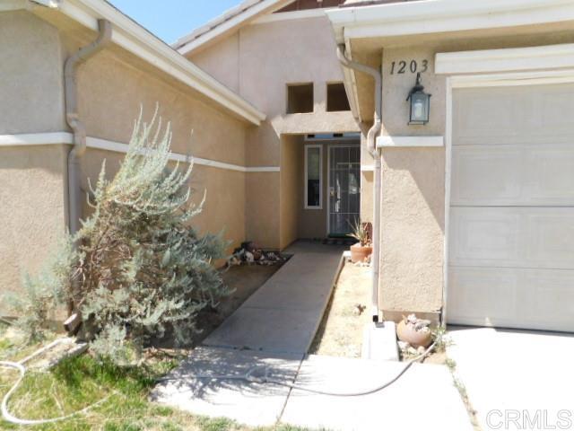 Perfect location at the end of the cul-de-sac with plenty of visitor and additional parking just across the road. Access to RV parking and walking trail just a few steps away. Popular 1628 sq. ft. 3BD, 2BA model with many special upgrades. Luxury vinyl plank flooring throughout, granite countertops and decorative tile in kitchen, custom concrete in patio and many other unique touches. A big beautiful custom shed enhances your options for extra storage or a private little hide-away outside. Fireplace with gas light separates the living and dining room. This gated community boasts an expansive play area with a sparkling pool, basketball courts, walking trail, picnic areas and lots of open space. Water and sewer are per the County and included in your property tax.