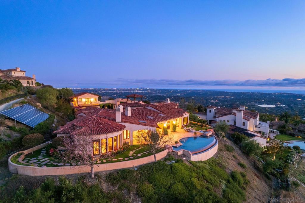 Custom built by the current (original) homeowners, this one of a kind SINGLE STORY stunning hilltop home boasts forever panoramic ocean, sunset & mountain views. Sited on a premier lot in the private, gated community of Cielo, this residence was thoughtfully designed to showcase its picturesque surrounding scenery...nearly all of the rooms showcase captivating views. The main house offers: spacious family room with floor to ceiling windows; gourmet chef’s kitchen incl. Viking apps; extensive countertop/island space, ample cabinetry & storage; butler’s pantry leads to formal DR near wine cellar closet; cozy LR; three bedrooms & two opt'l bedrooms (currently used as home offices). Primary retreat includes spa-like bathroom, walk-in closets and optional room perfect for gym equipment or a nursery. Large guest house above the garage could also be used as an artist’s studio or private office. The home’s unique mirador (viewing tower) offers a serene spot to savor the property’s commanding views (not to mention some of the best 4th of July fireworks!). Beautiful landscaping, infinity edge pool with spa & outdoor entertaining area create the perfect atmosphere for enjoying San Diego’s indoor/outdoor lifestyle. Owned solar panels (45) result in major electric savings (current owners' end of year true up is pretty much non-existent). Cielo means “sky” which is exactly where you’ll feel you are when you spend time in this special home. HOA fee grants access to Cielo Club amenities: gym; 2 pools; tennis; pickleball; etc. Minutes to the heart of RSF, coastal close & top rated schools!