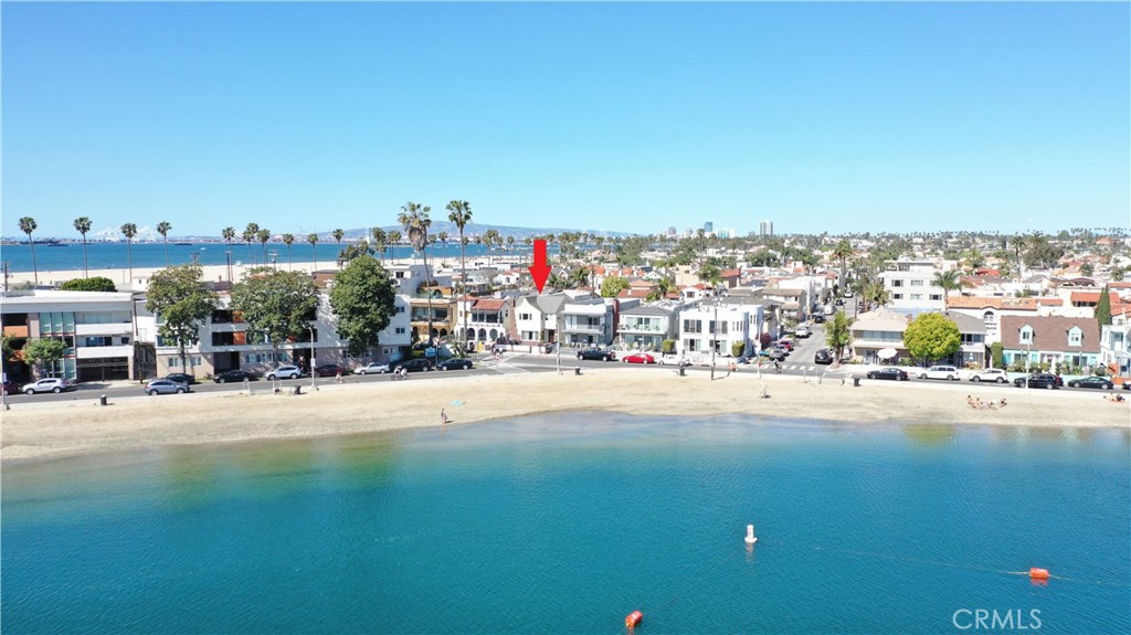 Rarely on the market Beach front Spanish Duplex that has been upgraded throughout!
A gorgeous shoreline gem that sits proudly across from Alamitos Bay and just short steps from the sandy beach. The sizeable 2 bedroom, 1 bathroom upstairs unit features beautiful hardwood floors throughout, a living room plus a small office space with panoramic beach views, and a formal dining room. The kitchen has been remodeled with newer high-end appliances, a small in-unit laundry area with hookups for a stackable washer & dryer, and lastly a large patio area/back deck off the kitchen that is great for entertaining. The spacious 1 bedroom, 1 bathroom downstairs unit boasts those beautiful hardwood floors again, a huge living room with expansive bay views and a warm romantic fireplace. The kitchen has been remodeled with high-end appliances and eat-in dining, a small in-unit laundry area with hook ups for a stackable washer and dryer. Additionally, this beautiful beachfront building includes an expansive brick beachfront deck ideal for breathtaking ocean views and unforgettable entertainment, a large 2-car garage, upgraded electrical panels, dual pane windows throughout, central heating and more! Residents of this beautiful duplex can enjoy swimming and windsurfing in the bay, sailing the swells, sunbathing in the warm sun by the shore, taking a short stroll 2nd Street for its unique boutiques, restaurants, and entertainment spots, as well-as the other endless amenities that the community of Belmont Shore has to offer. Ideal for owner-occupancy with a beautifully appointed unit to call home while generating income from the other. Don’t miss this rare opportunity!