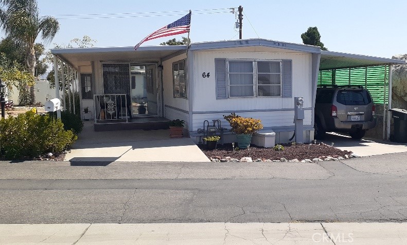 Charming manufactured home in a 55+ Community. 2 bed 1 bath with a large closed in sunroom . Lots of upgrades, new water heater, new subfloors and laminated wood flooring throughout. New water heater, one year new AC wall unit cooler and a master cooler evaporator cooler as well. New freestanding stove . Bathroom has new subfloor and toilet. both bedrooms have built in dresser drawers and closets, also a desk in master. Large back and side yard that is maintenance free with gravel but can be turned into great garden area there are a couple fruit trees and a beautiful large King palm, and has six foot vinyl privacy fencing. 2 shed, front and back porch's with awnings. Front porch has new step up deck . Covered cement carport with awning. Community has a pool, laundry facilities, office and club house. Park is in a rural type setting mountain views surrounded by open space . Very quite. Close to Diamond Lake where you can go fishing, water park and museum. Echo hills golf course around the corner lots of shopping and restaurants. Appointment only, Park manager approval required. Space Rent $765 a month. Home sold as Is.