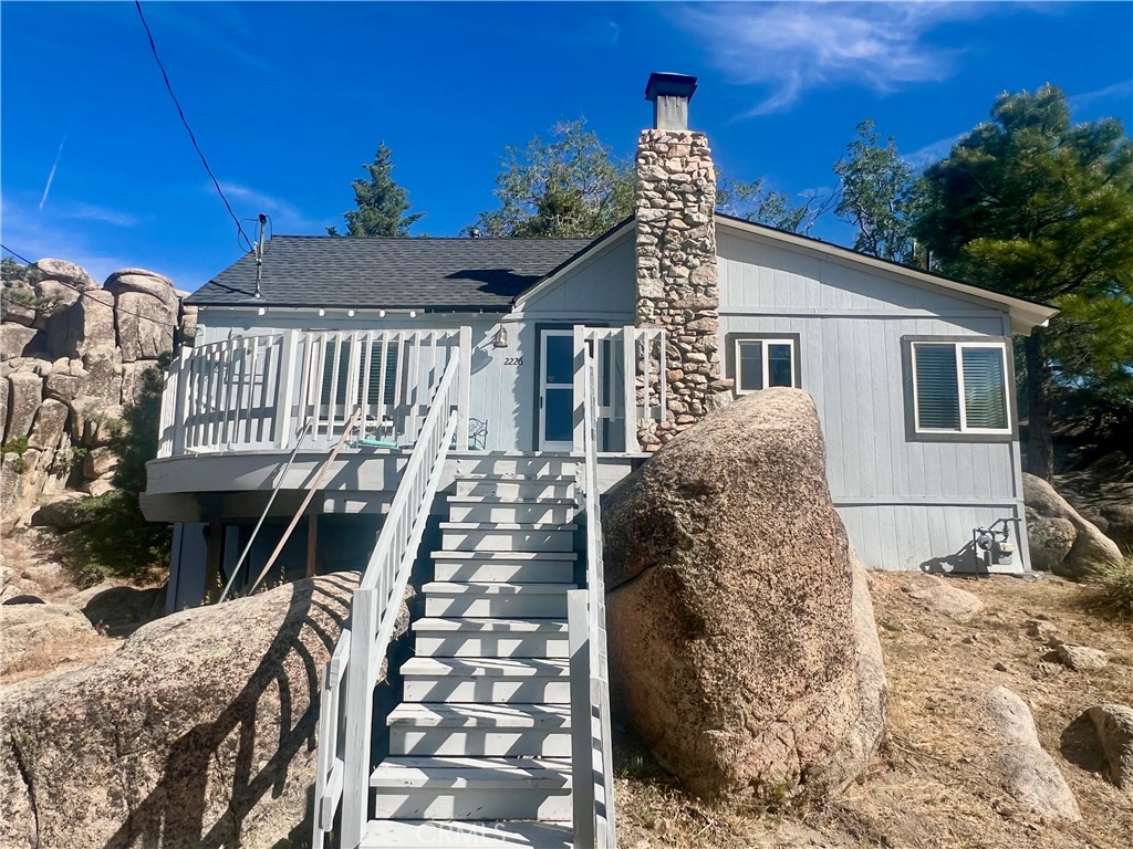Imagine waking up to breathtaking views of Arrowbear Lake and the surrounding valley, all from your cozy retreat up on the rocks. Nestled on three lots, this charming cabin offers an unparalleled sense of tranquility and connection with nature. This recently remodeled 540-square-foot cabin boasts a surprisingly spacious main living area featuring a beautifully restored, original stone fireplace. This historically significant element has been expertly cleaned, restored, and inspected by a certified chimney sweep, ensuring both its aesthetic appeal and safe operation. The addition of a remodeled attic loft provides over 60 square feet of additional, comfortable sleeping space. Extensive outdoor living space is provided by a large deck and a stone patio, perfect for relaxation and entertaining. Imagine enjoying your morning coffee while taking in the stunning lake views or hosting gatherings against the backdrop of a breathtaking mountain sunset.This cherished property, lovingly maintained by the same family for over 55 years, represents a unique opportunity to own a piece of Arrowbear Lake history, complete with modern amenities. It's more than just a cabin; it's an invitation to create your own cherished family memories in a truly exceptional setting. Just minutes to the local ski resort and hiking trails make this the perfect getaway spot!