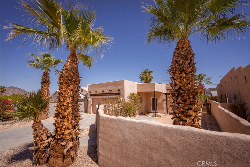 Dip your toe in year-round resort living in La Quinta Cove. This long-term rental offers Santa Fe flairs, open and spacious floor plan with fresh painted walls, and private outdoor living spaces surrounded by majestic mountain views. Every corner of the house is filled with natural light. Kitchen, dining, and living room have integrated open space, and boasts desert landscape, privately secluded wraparound fence through double French doors. Wide open kitchen counter offers four-stool space in addition to the dining sitting area for family/friends gathering. Two built-in floor-to-ceiling storages in the living room and ample kitchen pantry separately. Sizable master bedroom has a walk-in closet and direct access to patio-covered backyard, nicely shaded with vibrant colors of bougainvillea. Neutral off-white wall paint will accommodate any furniture you will bring in. Tenant pays all utilities. Trash and gardener included in rent. 1 year minimum lease. Must have good credit/rental history and verifiable income of last 2 pay stubs. Showings by appointment only.