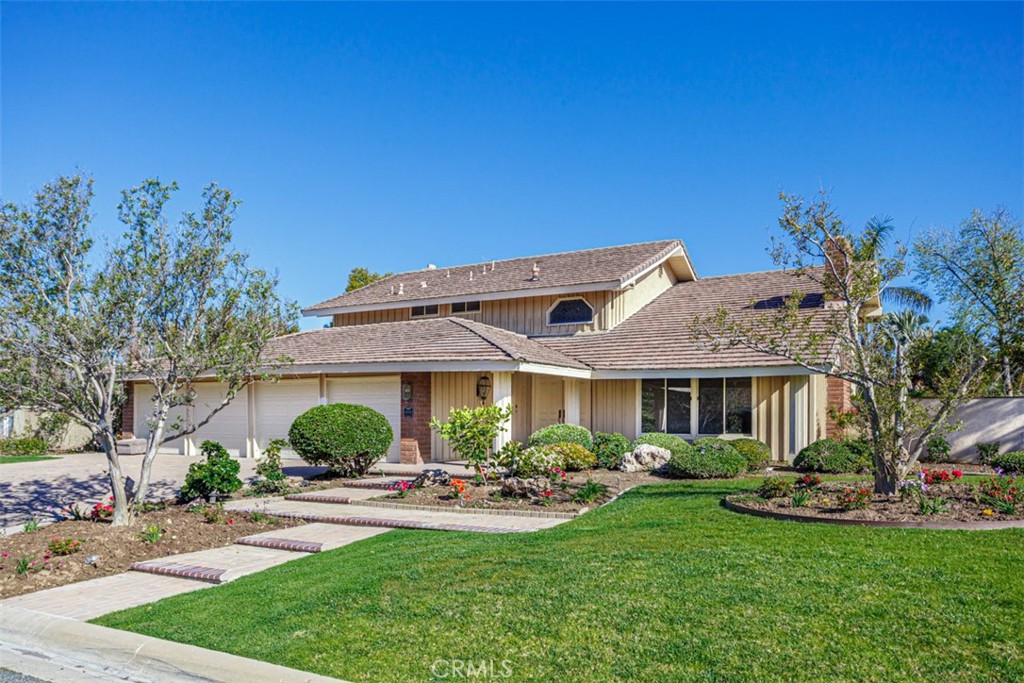Beautiful home tucked away in a hidden cul de sac, entirely remodeled with new paint,new flooring, appliances,refrigerator, baths all upgraded, lighting upgraded, new kitchen counter tops, Show beautiful. The backyard is a paradise with many valuable fruit trees, roses, and high quality plants. Gated access in the rear of the property. Rare four car garage .separate storage house on side of property (no bath)