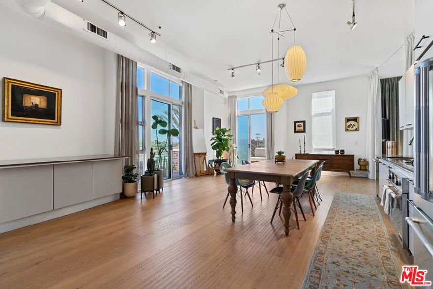 Welcome to your light-filled, 1.5 bedroom, 2-bath w/den, corner unit in the highly sought-after Steel Lofts building. // What to know: This beautiful architectural loft with only one-shared wall offers newly remodeled floors, as well as newly painted cabinets and walls throughout. Enjoy entertaining guests or just taking in the stars at night on the two outdoor balconies including the wraparound patio with magical views of the city lights providing the perfect California indoor/outdoor connection. The large curtain room dividers provide great versatility and allow for optional room separation including the spacious den area that can be an additional guest bedroom or work from home office space. // What you'll love: Enter a voluminous, sun-drenched open floor plan with high ceilings, large floor-to-ceiling windows, beautiful wide-plank European oak floors, and top-of-the-line fixtures & finishes. The gourmet kitchen features stainless steel Jenn Air appliances, European cabinets, and Caesarstone counters as well as a large open dining space for casual gatherings. Retreat to the primary bedroom with barn door sliders and designer bath with over-sized shower with 2 shower heads & a sit down bench. The second bath includes high-end fixtures and soaking tub. // Additional features include: Washer & dryer in unit, secure building with only 28 units and gated garage with 2 side-by-side parking spots, along with 14 guest spaces. There is also a community sun deck on the 4th floor with fantastic views. Notable about the neighborhood: Located close to all the Westside attractions including; beaches and marina, shops, theaters, restaurants, the nearby Marina Marketplace and minutes away from Abbot Kinney. It's the perfect sanctuary for your urban lifestyle.