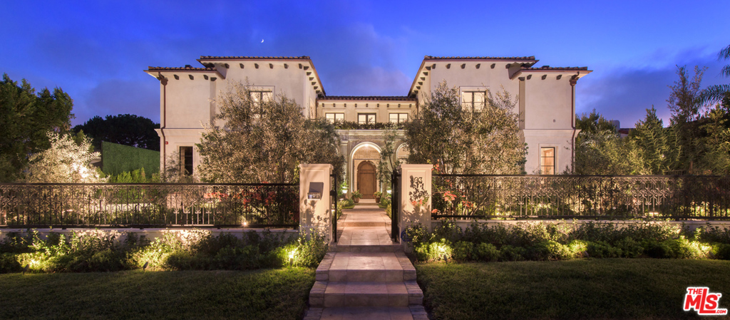 One of the finest examples of new construction in the Beverly Hills flats. True to its style, this one-of-a-kind Med. captures the eye w/ all that it tastefully offers. This architectural masterpiece combines the warmth of European luxury, w/ the modern feel of today, w/ its exquisite features and finishes throughout. Enter through wrought-iron gates into a peaceful courtyard, which boasts a breathtaking historic stone archway imported from an old Italian church. A voluminous atmosphere awaits, w/ a soaring foyer, grand-scale rooms & an abundance of natural light. Highlights include a beautiful living room complete with 1 of 9 unique French fireplaces, a chef's kitchen & an inviting wood-paneled library. The master suite is a resort unto itself due to a charming sitting area, & dual bathrooms w/ custom marble finishes that lead to an expansive outdoor terrace with views over the pool, patio, and manicured gardens. Perfect for entertaining.