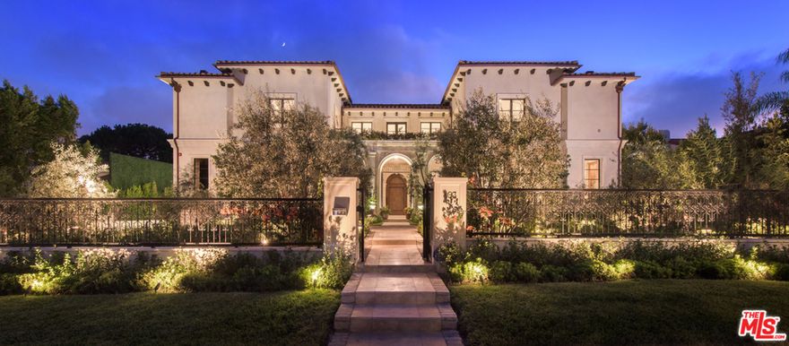 One of the finest examples of new construction in the Beverly Hills flats. True to its style, this one-of-a-kind Med. captures the eye w/ all that it tastefully offers. This architectural masterpiece combines the warmth of European luxury, w/ the modern feel of today, w/ its exquisite features and finishes throughout. Enter through wrought-iron gates into a peaceful courtyard, which boasts a breathtaking historic stone archway imported from an old Italian church. A voluminous atmosphere awaits, w/ a soaring foyer, grand-scale rooms & an abundance of natural light. Highlights include a beautiful living room complete with 1 of 9 unique French fireplaces, a chef's kitchen & an inviting wood-paneled library. The master suite is a resort unto itself due to a charming sitting area, & dual bathrooms w/ custom marble finishes that lead to an expansive outdoor terrace with views over the pool, patio, and manicured gardens. Perfect for entertaining.