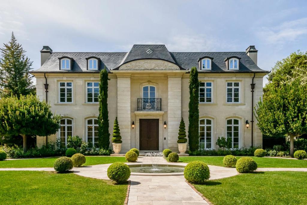 Radiating from a quiet court of ambling estates in Atherton, "La Maison du Soleil", with gardens like Versailles and a sprawling layout that's equal parts comfort and grandeur, elevates luxury living to a new level. Custom architectural details crafted by French and European artisans, travertine and rare marble slabs, meticulously curated grounds of meandering paths through sculpted trees and trellised vines make for a romantic setting. Sip wine under the cool keystone ceiling of a tasting room designed to hold 1,500 bottles cradled in Mediterranean tiles. Relax in a movie theater that rivals a cinema with a concession stand and a door featuring a porthole. Appreciate the allure of light that illuminates arched bridgeways between rooms and streams through curved French doors flooding every corner of the home with sun.
