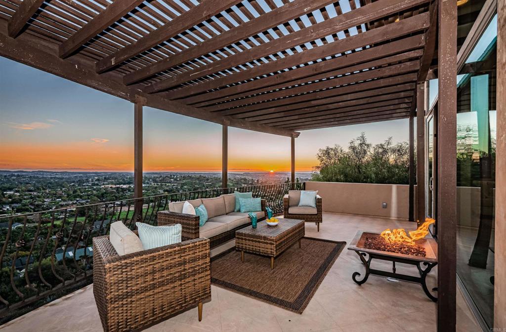 Exquisite Custom Estate with Breathtaking Views Nestled on 3.75 acres of pristine land, 2362 Edgehill Road stands as a one-of-a-kind architectural masterpiece, offering unparalleled privacy and luxury. Designed by the owner in collaboration with renowned local builder Norbert Waldenmayer, this stunning 5,749 square foot home was completed in 2003 and boasts contemporary design, exceptional finishes, and panoramic 270-degree views stretching to the ocean and Catalina Island. As you enter the gated community, the sense of exclusivity and security is immediate. A long, private driveway leads you through beautifully landscaped grounds, showcasing an array of native plants and chaparral carefully chosen by the owner. The freshly sealed stamped concrete spans nearly 10,000 square feet, including the impressive circular driveway that culminates at the four-car garage and front entrance. Step inside to find a grand entrance with oversized travertine flooring, custom cabinetry, and marble countertops. The stunning stone façade adds a warm, welcoming touch, while the family room’s fireplace offers a cozy, ambient glow that enhances the entryway. The layout of the home is ideal for both private living and entertaining, with easy access to the main living areas or the private bedroom wings. The expansive living room features floor-to-ceiling windows that flood the space with natural light and highlight the breathtaking views. A built-in wet bar and access to a spacious patio create a seamless indoor-outdoor living experience, perfect for entertaining guests. The chef’s kitchen is a true highlight, featuring a massive 7’ x 10’ island that comfortably seats 6-8 people. Surrounded by panoramic views, this culinary haven boasts granite countertops, high-end Dacor appliances, including a six-burner gas grill with electric dual ovens, and a Sub-Zero built-in fridge/freezer. Adjacent to the kitchen is the formal dining room, perfect for large gatherings, measuring 16’ x 15’ with access to a view deck complete with a gas BBQ and seating area. On the main level, you’ll also find a cozy family room with recessed lighting, a dual-sided gas fireplace, and fresh new carpet. An elegant office with custom built-in cabinetry provides the perfect space to work from home, while a state-of-the-art home theater room, featuring a giant screen, projector, surround sound, and blackout shades, offers an incredible entertainment experience. The private master suite, located on the south side of the home, provides a serene retreat with lush carpeting, private patio access, and sweeping views. The en-suite bath is a luxurious spa experience, featuring a double-sided vanity with marble countertops, a standalone clawfoot tub, and a custom-tiled shower with stunning westward views – perfect for watching the sunset while you unwind. Three generously sized secondary bedrooms, each with their own en-suite bathrooms, provide ample space and comfort for family or guests. The home also offers a four-car garage with abundant storage and freshly applied epoxy flooring. Additional highlights include three separate AC zones, a wine room with its own AC unit, a zoned radiant heating system powered by a boiler, a forced air system, a water pressure booster pump, and a fully paid-off 10KW solar system with 44 panels, making this home as energy-efficient as it is luxurious. 2362 Edgehill Road is a truly extraordinary estate that must be seen in person to be fully appreciated, especially when the city lights come alive at night. Don’t miss out on this rare opportunity—schedule your private tour today!