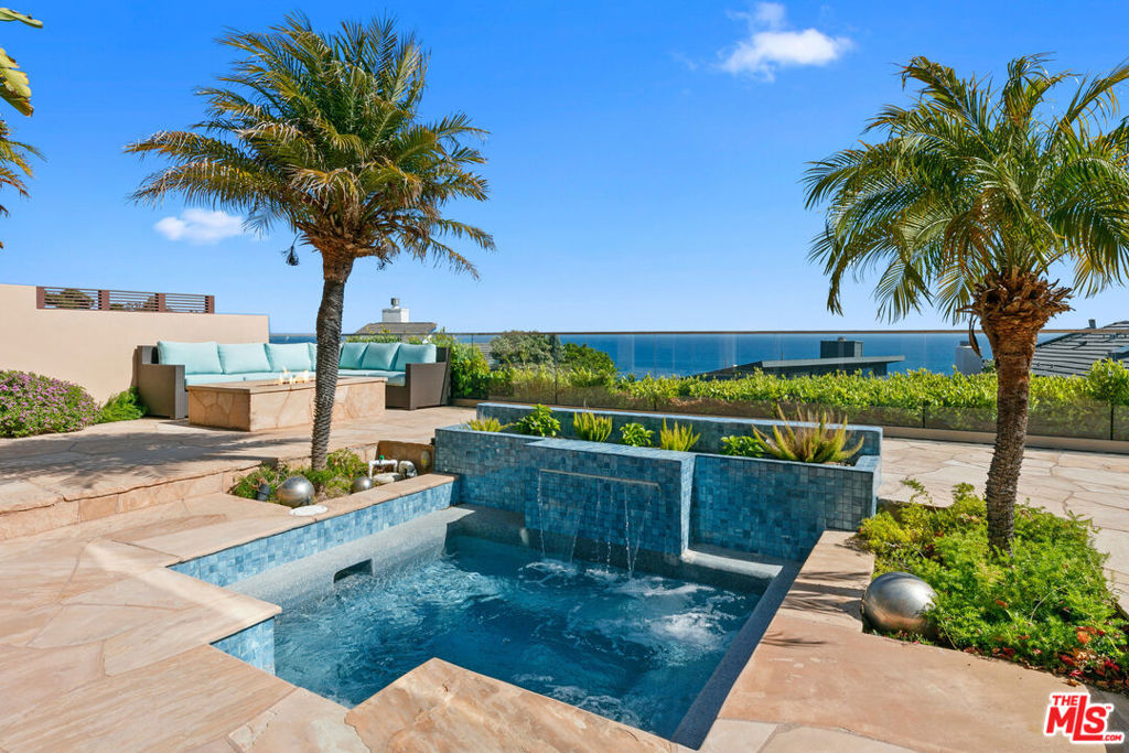 Discover the pinnacle of Malibu living in this breathtaking Broad Beach Road residence, where uninterrupted ocean views and elegant design come together to create the ultimate beachside retreat. Enter through a private, walled courtyard that leads to an inviting double glass door entry. Once inside, an abundance of natural light, newly installed wide-plank wood floors, soaring ceilings and expansive ocean vistas captivate your senses. The heart of the home is defined by two generous and distinct living areas where you can both relax or entertain. The beautifully remodeled gourmet kitchen, complete with custom cabinetry, Caesarstone countertops, top-of-the-line Viking appliances, and the convenience of double dishwashers makes it a breeze to entertain in style. Seamlessly blending indoor and outdoor living, large sliding glass doors open to a sun-soaked patio with a built-in BBQ, ideal for alfresco dining. Spend your days lounging in the California sun, relaxing in the newly remodeled jacuzzi, or gathering around the firepit under the stars. Upstairs, you'll find three spacious en-suite bedrooms, a cozy sitting area, and a well-appointed laundry room. The ocean-facing primary suite is a true sanctuary, featuring a private balcony with motorized shades, fireplace, spacious spa-like bath, and a generous walk-in closet. A second oceanfront suite offers a similar sense of tranquility with a luxurious bathroom and a unique indoor-outdoor shower experience from its private balcony. Whether you're seeking a full-time residence or the perfect weekend escape, this home offers it alljust a shell's throw from the beach. An attached two-car garage for your bikes, surfboards, and more and a connection to the Malibu West wastewater system are additional amenities. Now available just in time to enjoy summer in paradise. Offered furnished for those ready to move in and start living the Malibu dream.