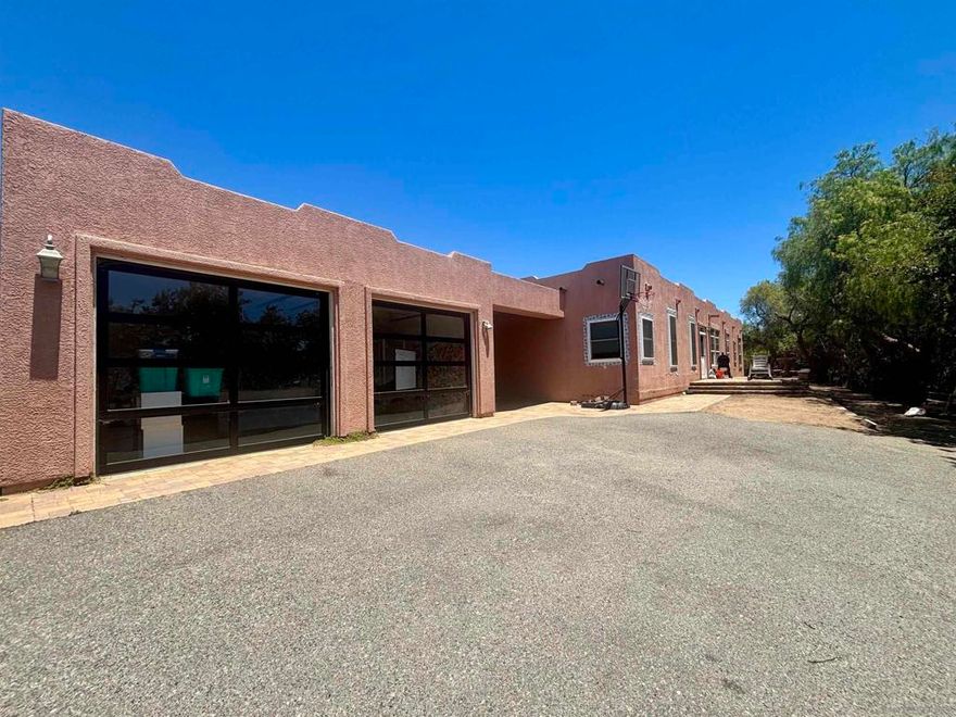 Handyman Special! Opportunity Awaits, Partially Renovated Santa Fe Style Home On 2.5 Acres, New: Roof, A/C, Flooring, Glass Garage Doors, Primary Bathroom w/ Steam Shower & Soaker Tub, Windows (some still need installation but material is there), Wainscoting In Living Area, Tankless Hot Water Heater. 9' Flat Ceilings. Needs Finishing Touches, Exterior Paint & Stucco Repair, Int. Paint, Yard Clean Up, Etc. The Kitchen And Other Bathrooms Are Original. Homes In The Area Updated Are Around $1.2M  Escape The Chaos Of The City And Relax In Safety At This Gated & Fully Fenced 4 Bed 3.5 Bath Santa Fe Style Home w/ Solar On 2.5 Acres In The Highly Sought After Community Of Bonsall. Where The " Bonsall Breeze" Flows Daily And Room To Spread Out. This Property Is Zoned A-70 With "W" Animal Designation Providing Opportunity For Horse Training, Breeding or Boarding Without The Time & Cost Of Obtaining A Use Permit, Or Enjoy Your Own Family Animals, Plant A Vineyard Or Other Crop. Room For RV And Toys