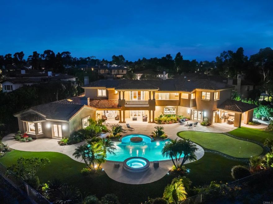 Exquisite Estate in Prestigious Meadows Del Mar! Set on over half an acre within the West Gate of exclusive, guard-gated Meadows Del Mar, this custom estate offers unparalleled privacy, timeless elegance, and breathtaking panoramic views. Thoughtfully selected by the original owner-developer for its premier cul-de-sac location and expansive vantage point, this 7,755 sq. ft. home is a masterwork of design by renowned builder Jim Ford. With 6 spacious bedrooms and 7.5 baths, including a luxurious downstairs primary suite, this residence effortlessly balances grand-scale living with warmth and comfort. A chef’s dream kitchen features top-tier appliances including SubZero side-by-side, double ovens, Miele steam oven, dual dishwashers, and a generous island that invites connection and culinary creativity. The home also includes a dedicated office, custom home theater, maid’s quarters, and versatile living spaces ideal for entertaining or everyday life. Outside, enjoy resort-style amenities including a sparkling pool and spa, covered loggias, built-in BBQ, putting green, and lush gardens filled with fruit trees, herbs, and roses. Whether hosting an intimate dinner or a celebration with 150+ guests, the outdoor areas are designed for unforgettable moments. Additional highlights include owned solar, remodeled kitchen, hardwood flooring, and whole-house water softener. Located in one of Carmel Valley’s most coveted communities, Meadows Del Mar is home to the Fairmont Grand Del Mar Resort, the private Tom Fazio-designed golf course, and Michelin-starred Addison. Residents enjoy top-rated schools, scenic trails, and easy access to beaches, dining, shopping, and major freeways. This is a rare opportunity to own a true legacy property in one of San Diego’s most prestigious enclaves.