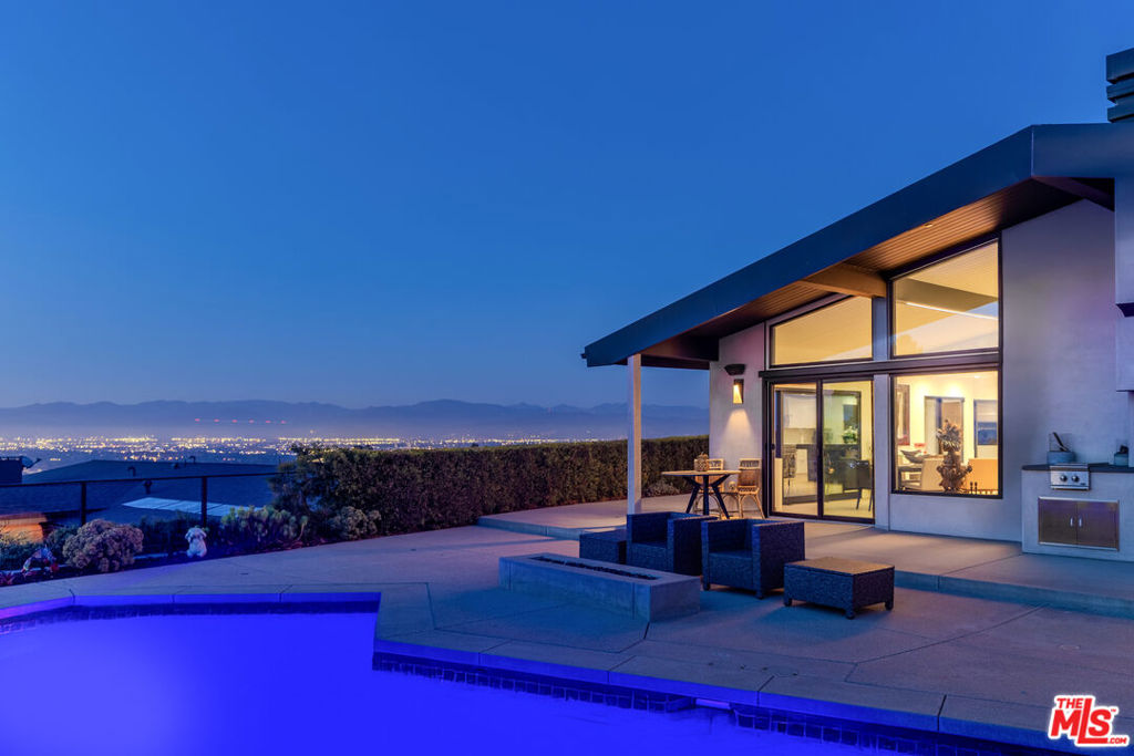 Jetliner Views!!! A rare offering in the prestigious Encino Hills, 4326 Coronet Dr delivers the ultimate in privacy, design, and breathtaking jetliner views.Tucked at the end of a long, gated private drive, this modern estate is a true hillside sanctuary, offering panoramic vistas from nearly every room.Built in 2019 and in immaculate, like-new condition, the home features 5 ensuite bedrooms thoughtfully arranged over two levels-two upstairs and three downstairs for optimal comfort and flexibility. The upstairs primary suite is a luxurious retreat with a spa-style bath, dual walk-in closets, and a private deck that opens to unobstructed views stretching across the valley.The dramatic great room is flooded with natural light, featuring soaring ceilings, walls of glass, and seamless indoor-outdoor flow. A sleek media room offers the perfect setting for movie nights, while a serene rose garden provides a quiet space to unwind.Outside, enjoy a stunning pool, sun-drenched terrace, and generous entertaining space, all set against a backdrop of sweeping valley views.Private, gated, and beautifully designed, this exceptional estate embodies the best of modern Encino living.