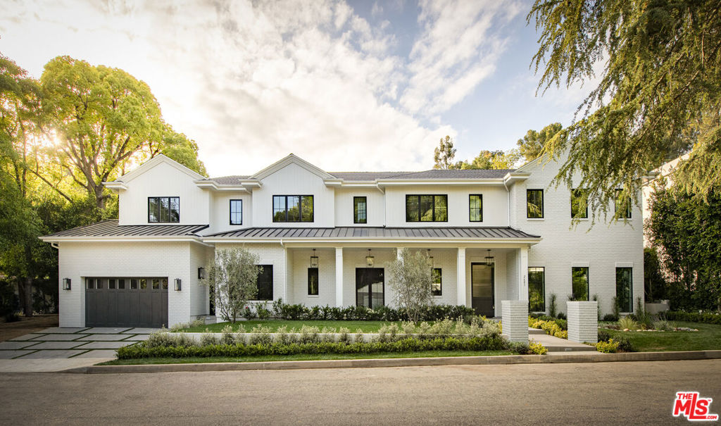 This fully custom FountainHead home (fully gated in approx. 10 days) embodies timeless luxury in 90210, where superior quality is evident from the moment you arrive. Crisp, clean lines lead to an inviting veranda, elegantly illuminated. Inside, the foyer welcomes you with a striking marble checkerboard floor, a view of the grand backyard (pool/hot tub photos to follow), and a magazine-worthy formal living room to your right-featuring full-height paneled walls and expansive picture windows overlooking the front yard. Designed for both function and style, the main living area seamlessly blends a spacious kitchen with a center island, a casual dining space, and a family room with custom built-in entertainment cabinetry. Floor-to-ceiling sliding glass doors open effortlessly to the backyard, creating a seamless indoor-outdoor experience. The first level also includes a guest bedroom, a private office, a formal dining room wrapped in high-end designer grasscloth wallpaper, a custom wine cellar, and an exciting home theater. A grand staircase with an elegant solid steel handrail and a large picture window leads to the upper level, where the primary suite impresses with soaring vaulted ceilings clad in T&G paneling, an ensuite reading room with a wet bar, a double-sided fireplace, and dual walk-in closets. The spa-like primary bath boasts a spacious steam shower, Waterworks fixtures, dual water closets, and heated floors. A serene outdoor terrace, spanning the length of the primary suite, offers the perfect retreat for morning yoga or a quiet read among the trees. Four additional ensuite bedrooms, each with vaulted ceilings, are located along a skylit hallway. Outside, the expansive, lush backyard is designed for effortless entertaining, featuring a pergola with recessed lighting, outdoor speakers, a built-in BBQ, and ample space for both daytime and evening gatherings. Custom pool design options are available to suit the buyer's preferences. Additional amenities include a Crestron Smart Home Control System, in-ceiling speakers, wide-plank white oak floors, a Wolf stainless steel range and convection steam oven, a Sub-Zero refrigerator, and two stacked washer/dryer units. Ideally situated near top-rated private and public schools, premier shopping, dining, and the Beverly Glen Center, this is a rare opportunity to own an architectural gem in a coveted location.