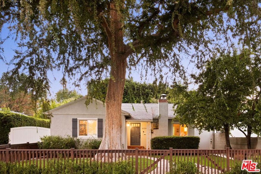 Set midblock beneath a stately elm, this updated yet charming three-bedroom two-bathroom Sherman Oaks home blends original character with thoughtful modern improvements. Sunlit interiors feature refinished wood floors, new windows with custom shutters, and a stylish kitchen with designer finishes. The primary bedroom opens to the backyard through French doors, creating an effortless indoor-outdoor connection. Surrounded by mature landscaping for true privacy, the backyard is exceptional in both scale and lifestyle offerings with a beautiful lawn, a Thermory four-person barrel sauna, and a custom-built detached office with power and AC that is ideal for working or creating at home. Located near highly regarded Kester Elementary and just moments from Ventura Boulevard's dining, shopping, and commuter access, this home retains its charm while delivering modern comfort at every turn.
