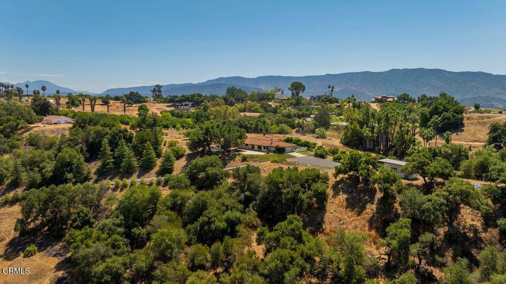 Perched on a private 7 acre hilltop with sweeping 360-degree views, 534 Fairview Road is being offered for the first time since its construction in 1984. This Spanish-style retreat spans approximately 1,800 square feet with three bedrooms and two bathrooms, all designed to bring the outdoors in. From sunrise to sunset, every room is framed by the dramatic mountain views, orchards, and valleys that define the beauty of Ojai.A long, gated driveway winds up to the residence, creating an immediate sense of privacy. Inside, timeless details include terra cotta tile floors, a wood-burning fireplace with built-in seating, and wide sliding glass doors that open to expansive patios. The kitchen features tiled countertops, new appliances, warm wood cabinetry, and a picture window perfectly positioned over the sink, offering breathtaking views with every glance.The floor plan flows effortlessly into the living and dining areas, where natural light fills the space and the mountains feel within reach. Each bedroom offers tranquil views, with the corner windows capturing an ever-changing canvas of the surrounding landscape.Outdoors, the property truly shines. Multiple areas are designed for relaxation and entertaining, from the shaded deck beneath mature oaks to the wide patios that invite dining under the stars. The landscaped gardens are complemented by a variety of fruit trees including orange, avocado, fig, apple, and more providing both beauty and bounty. A fountain and flowering beds add charm, while the hilltop setting ensures unmatched privacy.This is more than a home it is a rare opportunity to own a private retreat that balances timeless Spanish charm with natural abundance and unparalleled views. Just minutes from downtown Ojai, yet set apart on its own hilltop, 534 Fairview Road is a property unlike any other.Schedule a showing today and experience the beauty, privacy, and lifestyle this estate offers.