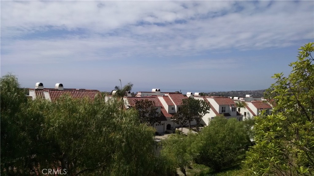 Single story end unit ocean view condo in gated "Encantamar Complex". New interior paint, newer laminate/wood flooring and newer carpets. Views from living room, dining room, master bedroom. All windows have coastline ocean views. Large deck perfect for lounging and enjoying Catalina sunsets. Spacious living room with fireplace. Walking distance to community pool, spa, clubhouse, gym. Close to transportation, restaurants and many amenities, yet very private. Please no pets or smokers.