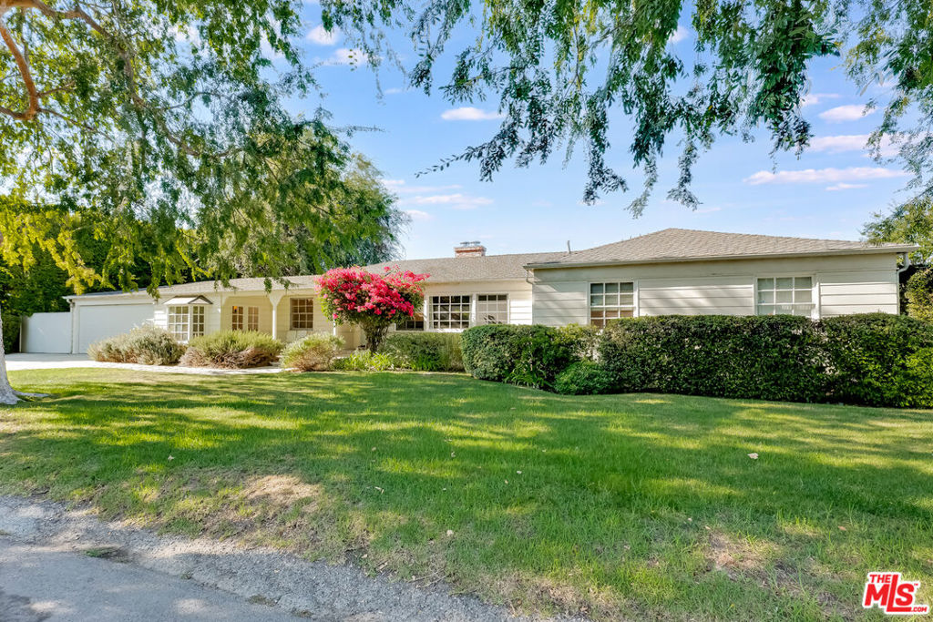 Location, Location, Location! Elegant Single-Story Ranch Style home situated in a prime Studio City setting. This beautifully appointed residence blends sophistication, comfort, and convenience. In close proximity to Ventura Boulevard, residents enjoy access to fine dining, shopping, and entertainment while still benefiting from the quiet, residential character that makes Studio City one of Los Angeles' most desirable neighborhoods.This beautiful home is designed for both everyday living and entertaining, offering a chef's kitchen with Viking and Sub-Zero appliances, custom cabinetry, and an open floor plan with a formal dining room. The living room, centered around a fireplace, creates a warm gathering space. The den/office with its own fireplace provides flexibility for work or relaxation. The primary suite offers a private retreat with an oversized walk-in closet, spa-like soaking tub, and separate shower. Two additional bedrooms share a full bath, complemented by a powder room. The garage is attached and has direct access through the laundry room. The exterior is equally inviting. A charming front porch and mature landscaping enhance curb appeal, while the private backyard offers both lawn and patio areas. Tall hedges create seclusion around the sport court, hot tub, and outdoor entertaining spaces providing the perfect setting for gatherings or quiet evenings. The home location delivers on every level with excellent schools, nearby parks, and close proximity to major studios. Ventura Boulevard places boutique shops, cafes, and everyday conveniences close at hand, while easy access to the 101 Freeway and Laurel Canyon Boulevard connects you seamlessly to the rest of Los Angeles.