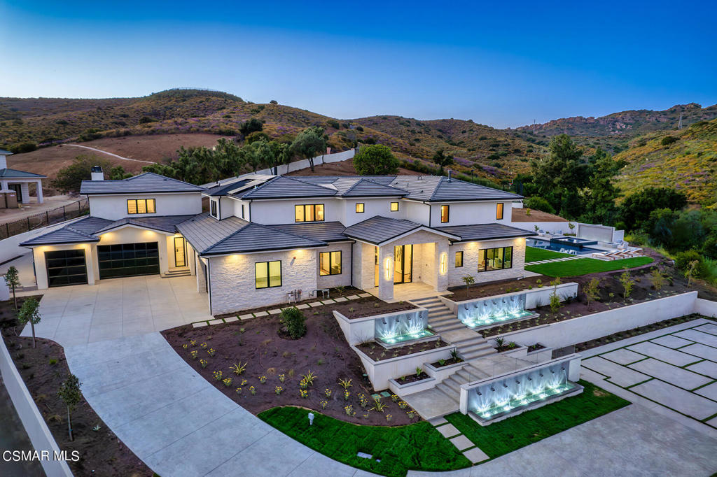 Extraordinary BRAND NEW transitional masterpiece with the premier ''end of cul-de-sac'' location in the exclusive High Country section of North Ranch! Ideally set behind private gates atop 2.44 acres with complete privacy and sensational views. This is a very rare and special find in this highly desired community! Set above street level and up a long driveway is this one of a kind showplace! Features include a VERY RARE 11 car attached garage and a special detached self contained guest house with living room, bedroom, kitchen, fireplace and bathroom. The grand main estate boasts 5 en-suite bedrooms, 6.5 bathrooms, ELEVATOR, soaring two story ceilings and a bonus room easily made into a theater, gym or office. The center island kitchen is absolutely spectacular. It provides state of the art appliances and cabinetry and opens seamlessly to the impressive family room with fireplace and multiple sets of sliders and oversized pocket doors. The primary suite is graced with a coffee kitchen, fireplace, sitting area, private viewing balcony and a beautiful spa like bathroom and enormous finished closet! The resort quality grounds are simply remarkable. There is a stunning pool with water feature, two firepits, PICKLE BALL/basketball court w/lights, outdoor kitchen and fireplace, multiple patios and viewing areas and massive manicured lawns all with complete privacy and explosive views. Other amenities include a smart home system, an abundance of extra on site parking, multiple cascading water features, custom glass front door with pivot movement, wine cellar, large fully finished laundry room with 4 included units and too much more to mention here. This is a one of one masterpiece with a perfect location in North Ranch. VERY rare and special to find new construction like this.