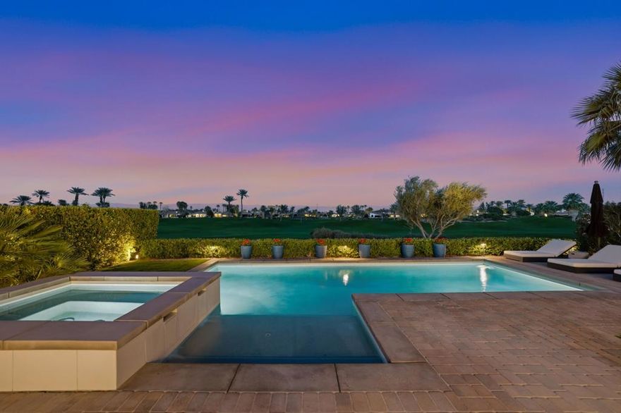 Experience luxury desert living at its finest in this stunning, designer-furnished 4-bed, 5-bath residence poised along the coveted double fairway of the 6th hole. From the moment you enter through the expansive private courtyard, the home unfolds with a seamless blend of modern elegance, refined finishes, and resort-level comfort. Inside, an open-concept great room welcomes you with soaring ceilings, clean architectural lines, and walls of glass that frame unobstructed views of the Rees Jones-designed golf course. Restoration Hardware furnishings elevate every living space with sophisticated style and impeccable craftsmanship. The gourmet kitchen is a showpiece of luxury and functionality, featuring sleek quartz countertops, subway-tile backsplash, and top-of-the-line Wolf and Sub-Zero appliances making it the perfect setting for the most discerning chef. A massive center island and custom cabinetry make the space both beautiful and highly practical. Flowing ceramic tile flooring extends through the home, adding warmth and continuity to every room. The primary suite is a serene retreat, boasting a spa-inspired bathroom with a freestanding soaking tub, glass-enclosed shower, dual vanities, and refined designer touches. Every guest suite offers comfort and privacy, each with its own en-suite bath.  The sparkling pool and raised spa capture sweeping fairway views, while the inviting firepit and built-in BBQ, paired with full audio/visual integration, create a resort-caliber setting for effortless outdoor living and unforgettable evenings. Whether you're hosting gatherings in the spacious loggia, enjoying morning coffee in the sun-drenched courtyard, or unwinding by the fire after sunset, this home delivers effortless indoor-outdoor living with unmatched style. Come live the life you've always imagined!