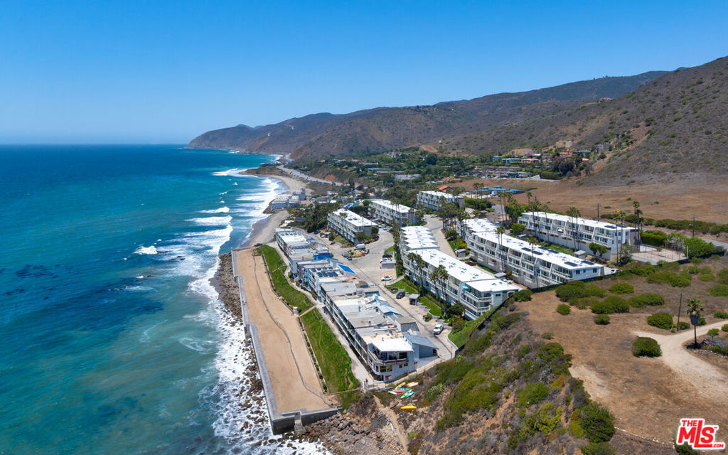 Brand new 2025 remodel - Welcome to the Malibu Bay Club located on an oceanfront bluff offering an incredibly serene beach lifestyle. Known for its cove beaches and natural beauty, this property is an ocean lover's paradise, mere steps from the sand. Whalers Lane is a two level 2 bedroom, 2 bathroom unit offering ocean views and feels very private located near the end of Whalers Lane plus you are so close to the water and the sounds of the crashing waves below. Completely remodeled in 2024/2025 and drenched in natural light, this ground floor unit features an open floor plan and sliding doors that open to decks on each level. The main level offers one bedroom and one bathroom, kitchen, dining and living area. The lower level offers 2 sleeping areas plus a second living area, dining area and full bathroom. Private laundry, A/C, beautiful tile floors with a hardwood look, new fixtures, finishes, electrical and plumbing throughout. 1 car carport plus 1 additional uncovered parking spaces. Don't miss this opportunity to own this renovated unit where you can bring your toothbrush and start enjoying just in time for summer. The furniture can also be purchased separately as well. The Malibu Bay Club is one of only a few beachfront complexes in Malibu. Gated with secured entry, beautiful pool area with spa and direct beach access to sandy coves. The community recently completed renovations to all the condo exteriors including new roofs, copper gutters, new exterior paint, tile and more.